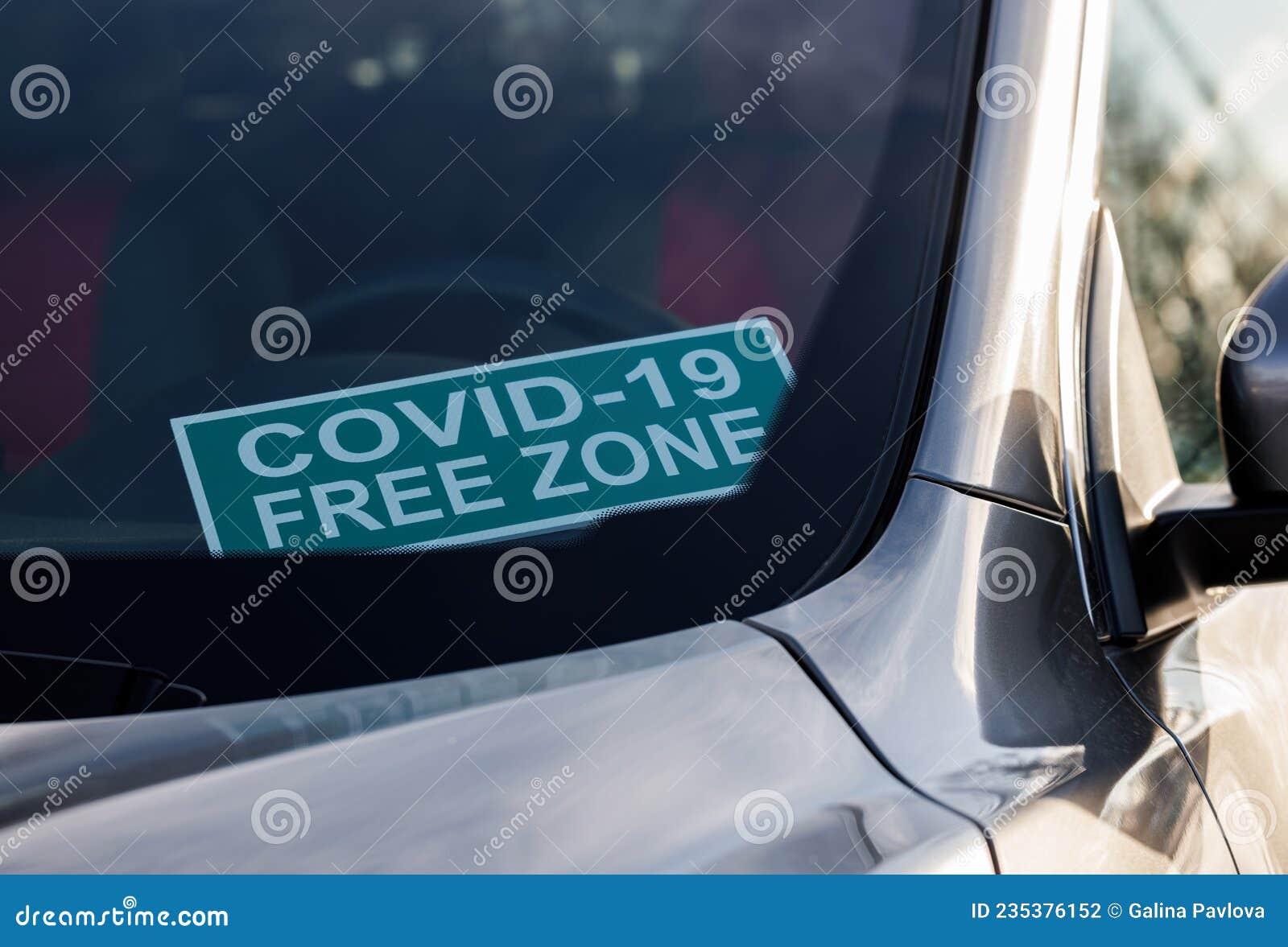 Covid19 Free Zone. a Cardboard Sign on the Windshield Inside the Car