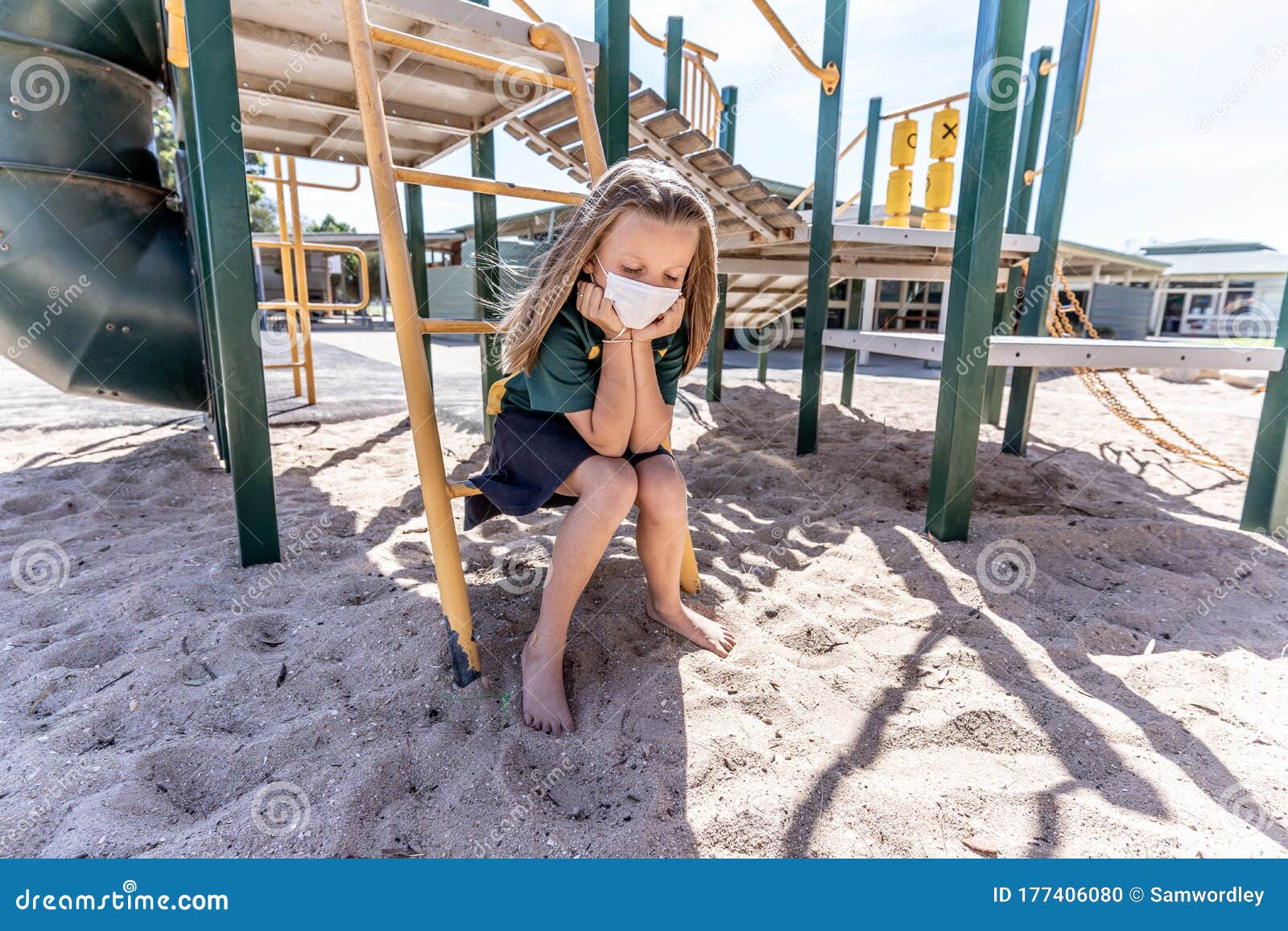 schools closures coronavirus lockdown. bored school kid alone in playground feeling sad and lonely