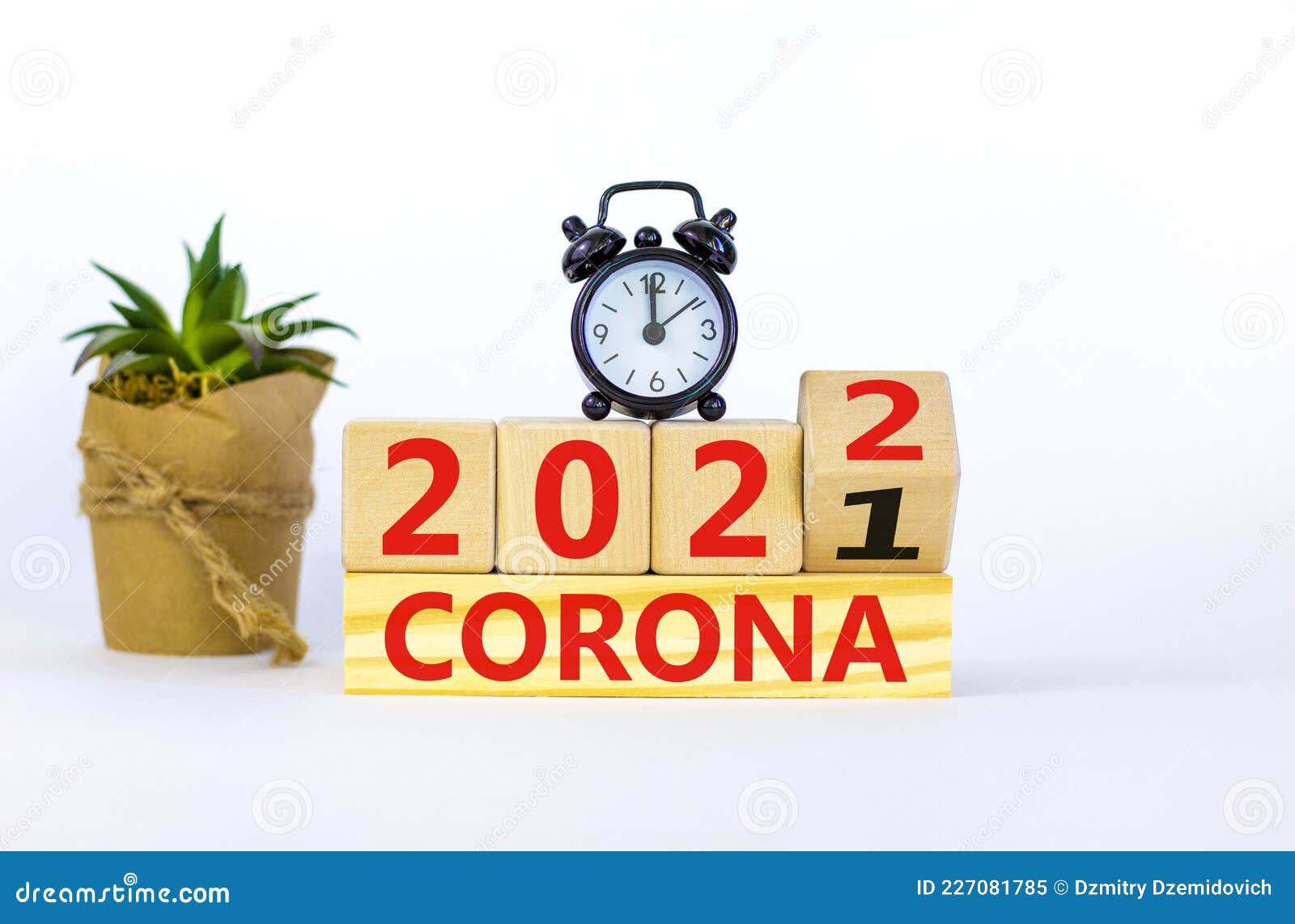 covid-19 pandemic in 2022 . alarm clock. turned a wooden cube, changed words `corona 2021` to `corona 2022`. beautiful w
