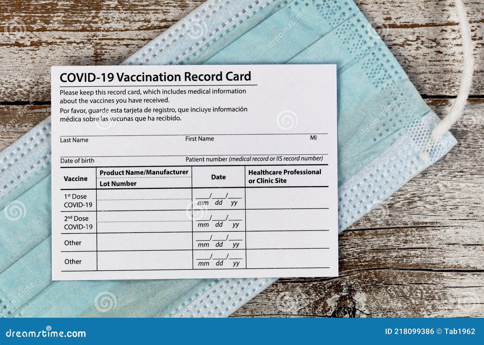 covid 19 vaccination record card with facemask in close up view.  individual record for use during the covid 19 coronavirus global