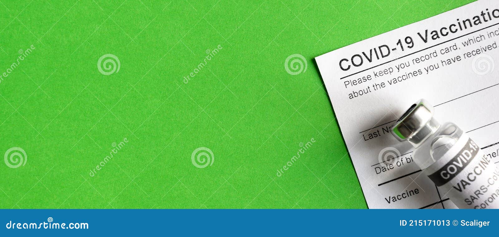 covid-19 vaccination record card on green background