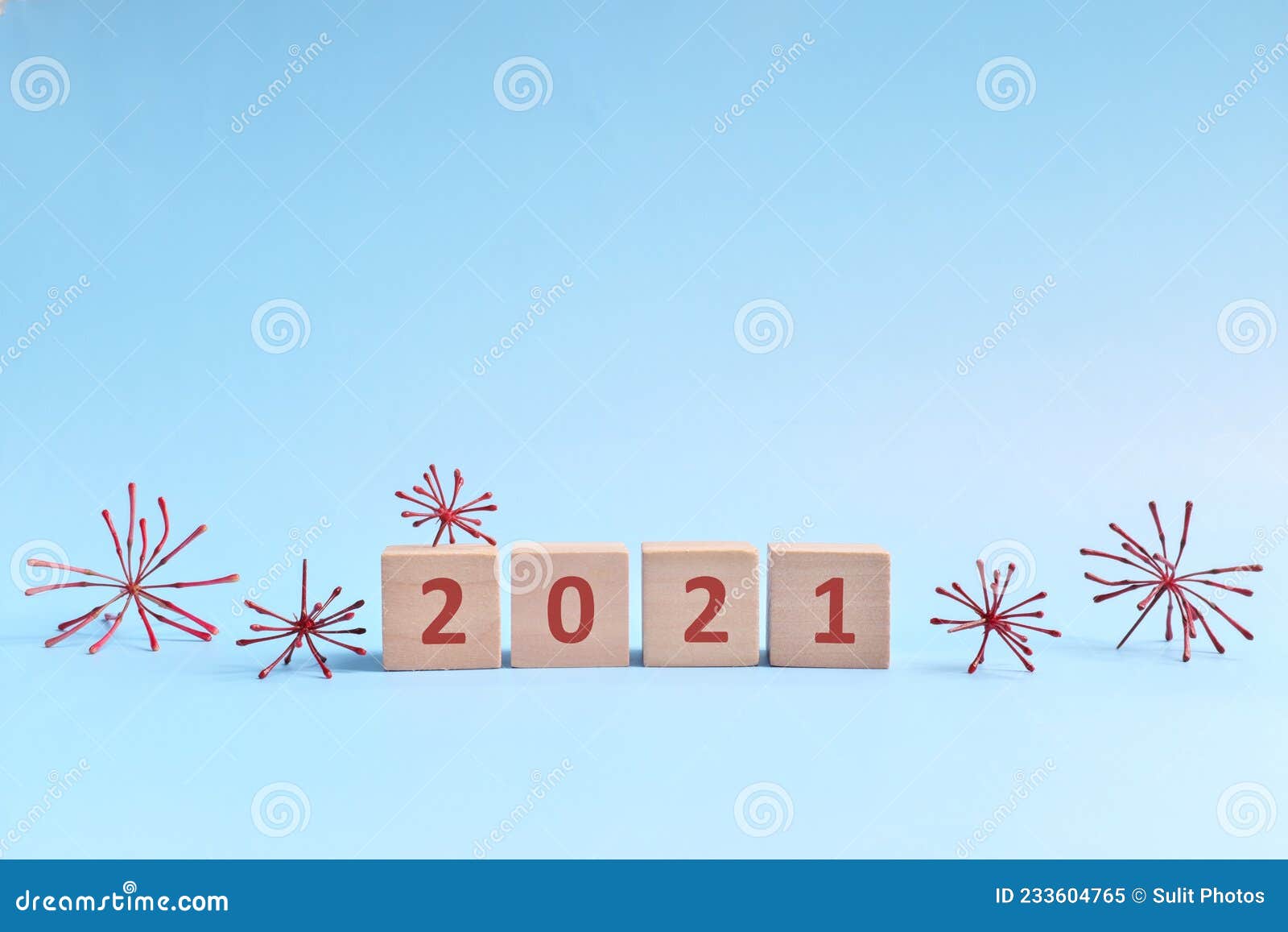 covid-19 year 2021 summary and review concept. wooden blocks typography in blue background with copy space.