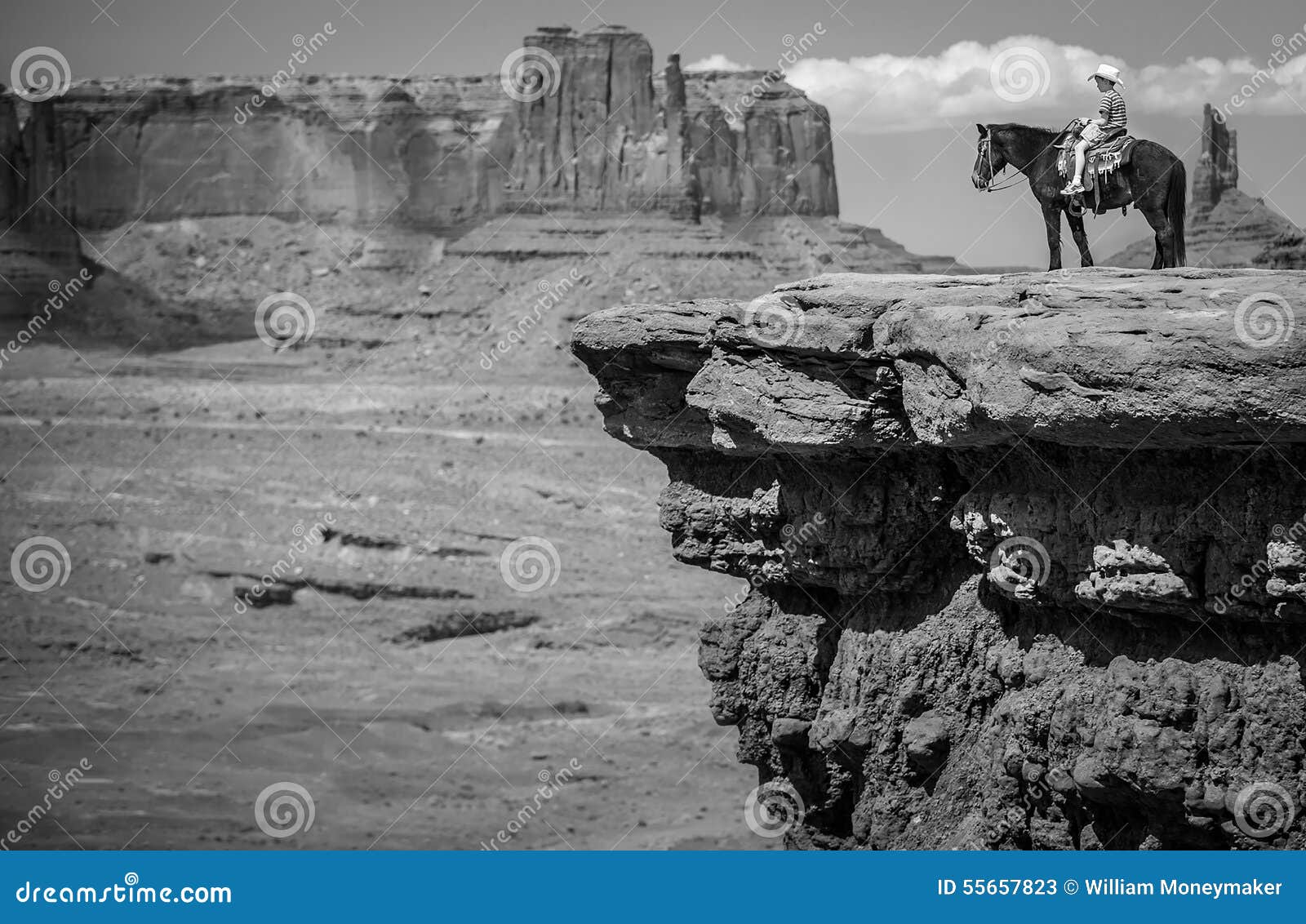 cowboy on horseback in monument valley