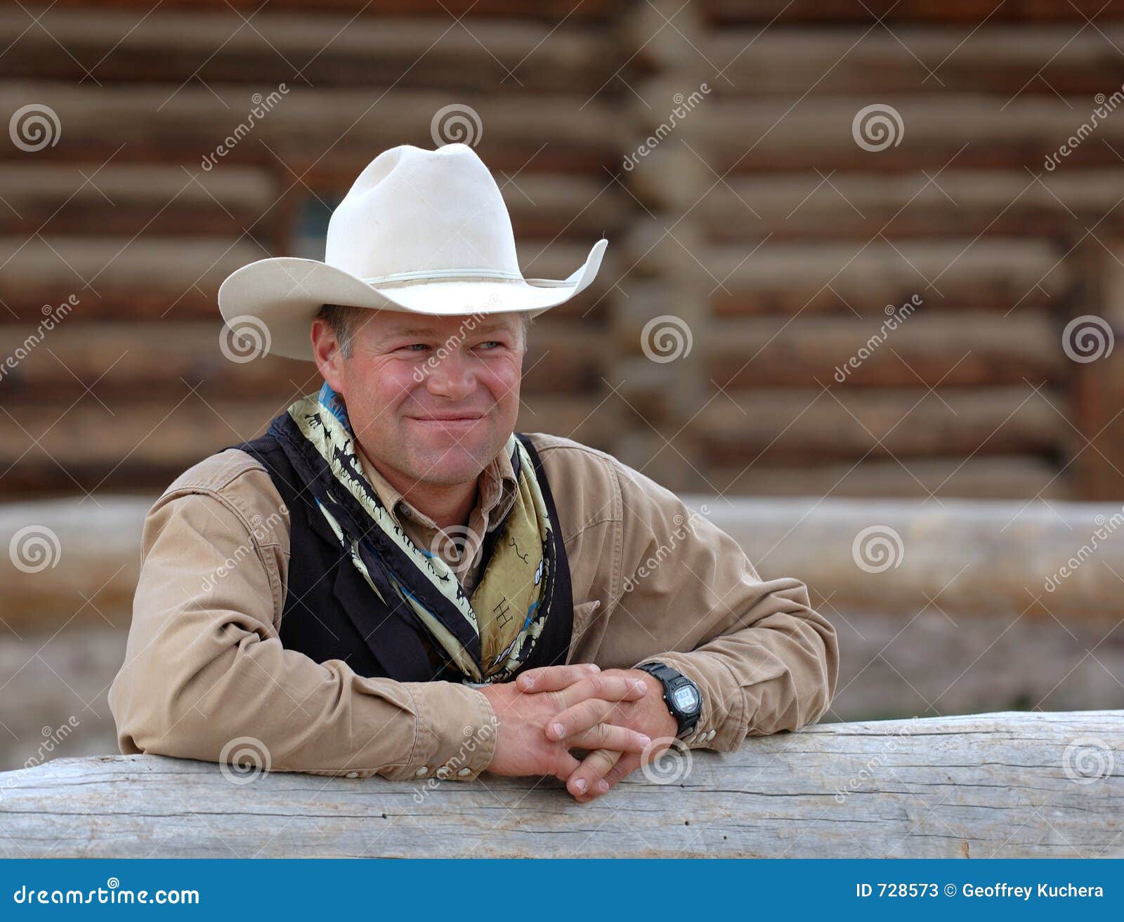cowboy leaning on fence