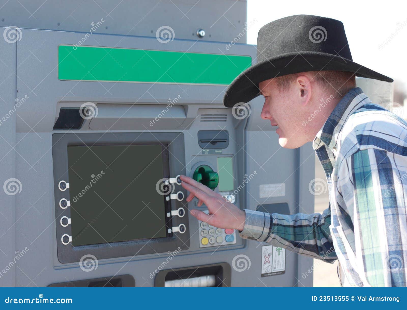 cowboy-using-atm-machine-23513555.jpg