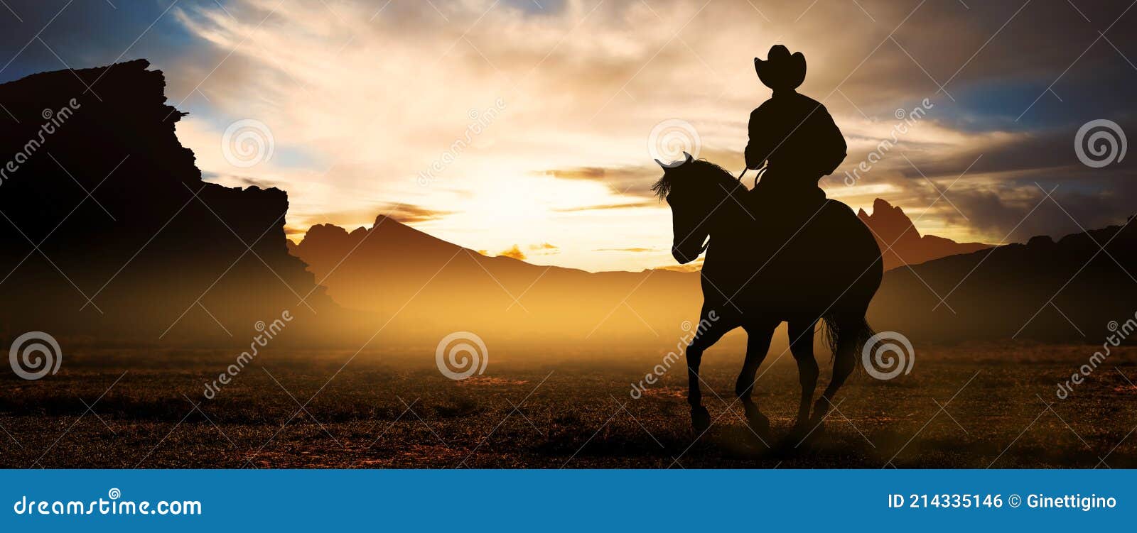 cowboys on horseback at sunset