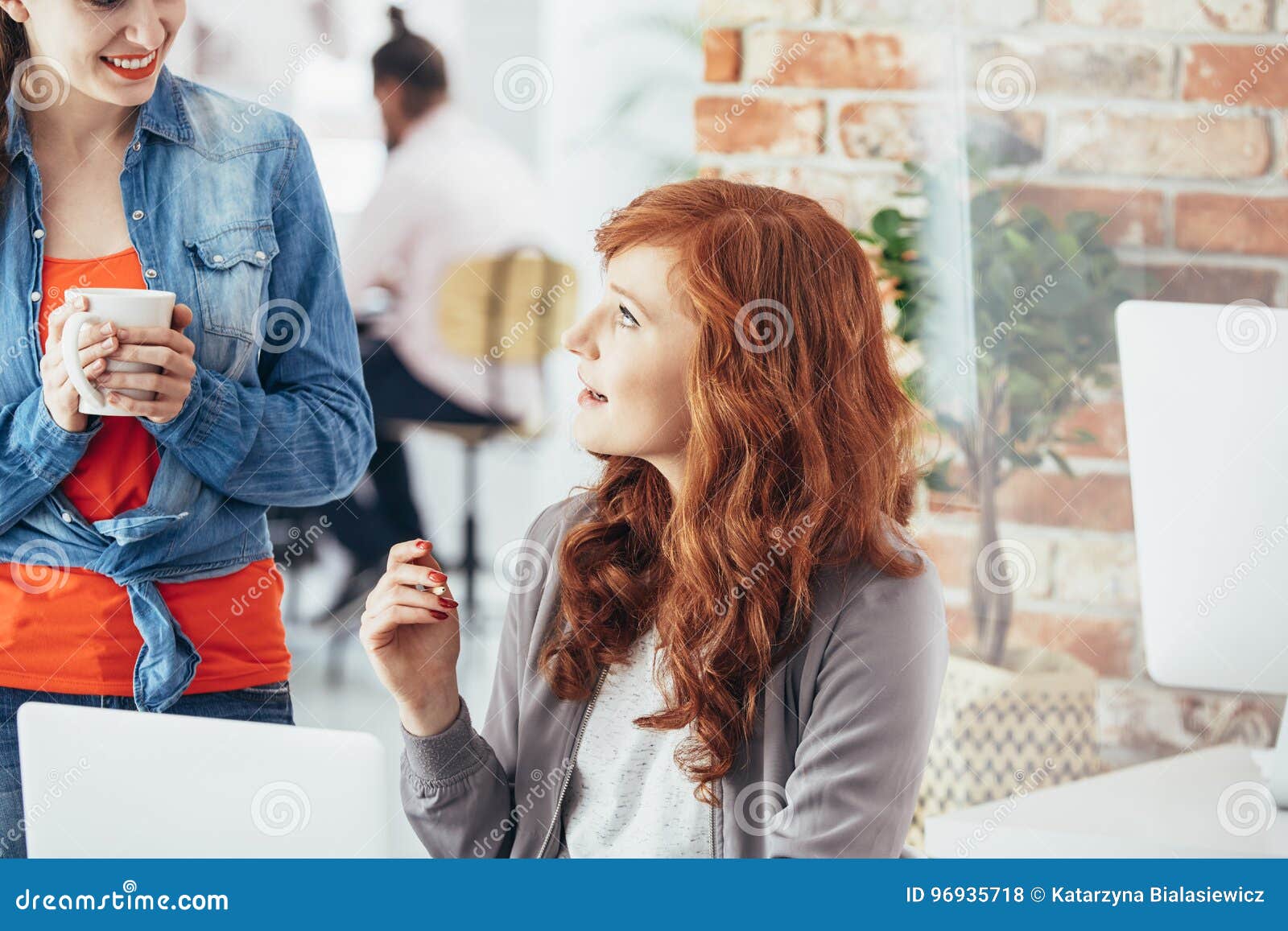 coworkers talking in office