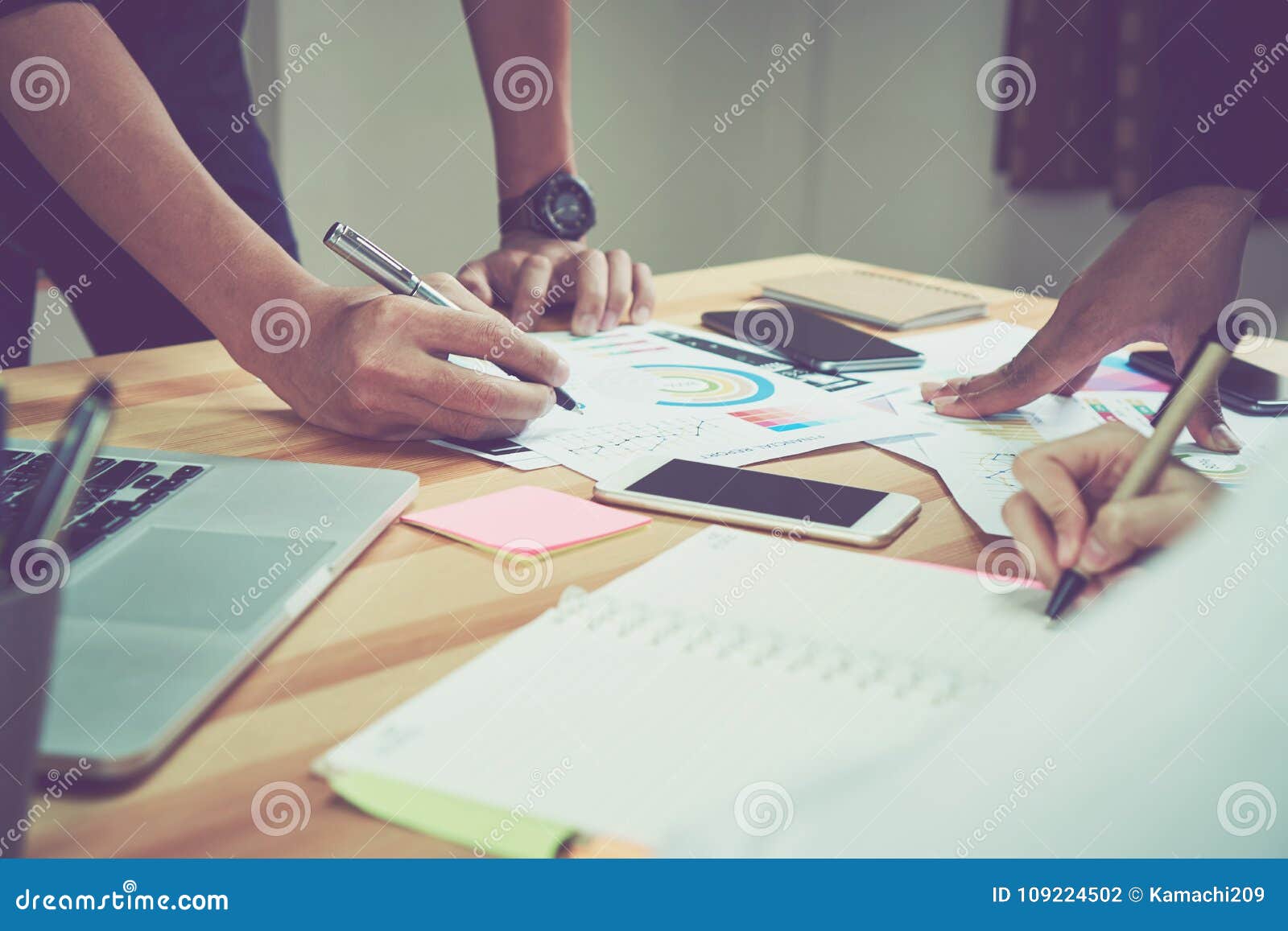 coworking space, team working together. modern workplace desks and computers and documents.