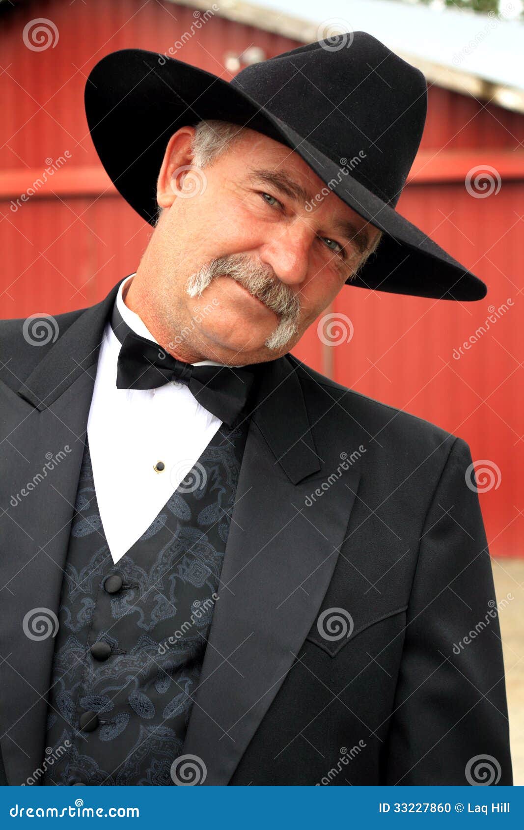 coy formal cowboy middle aged american rancher full mustache wearing western wear barn background shallow depth 33227860