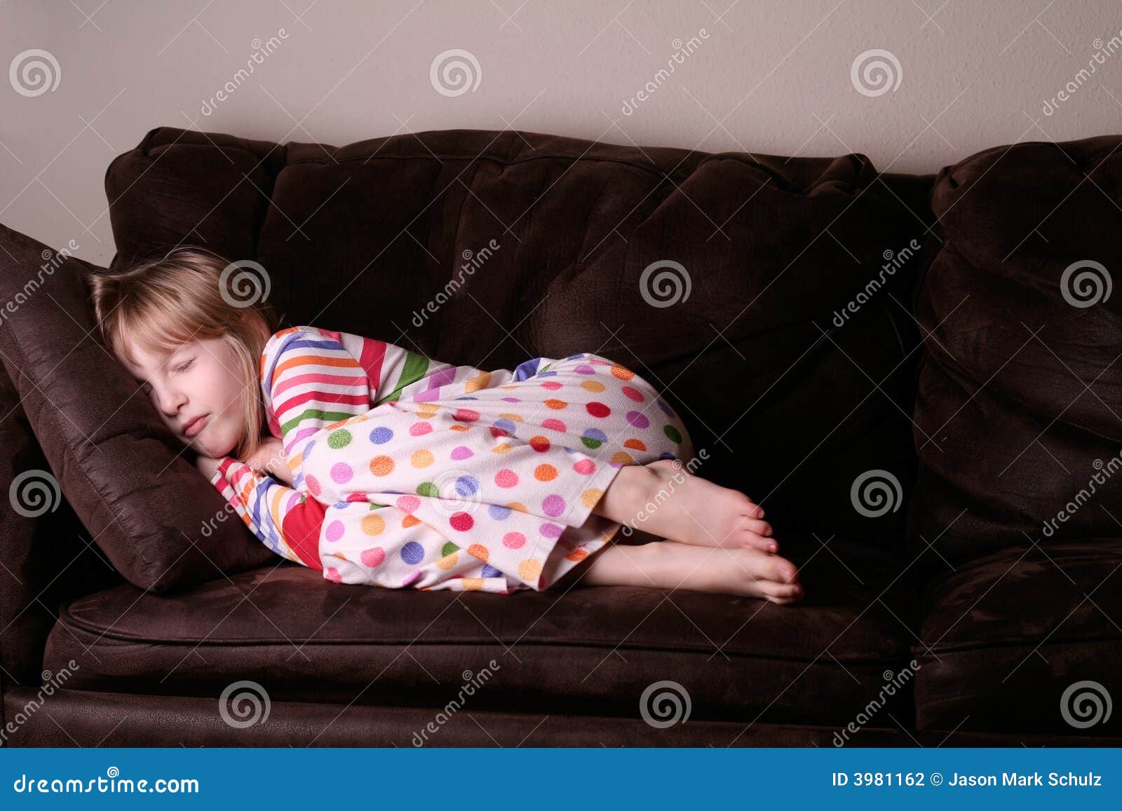 cozy asleep in pajamas on sofa