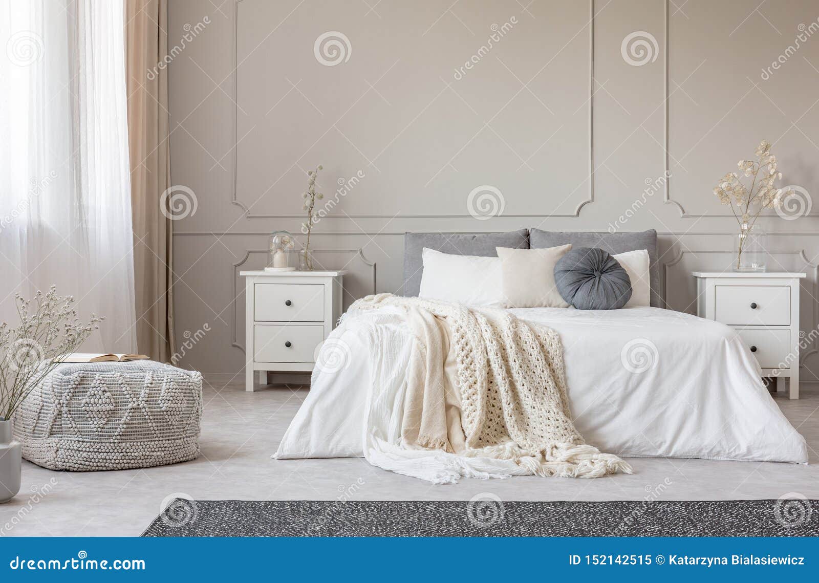 cozy cream colored woolen blanket on king size bed in bright bedroom