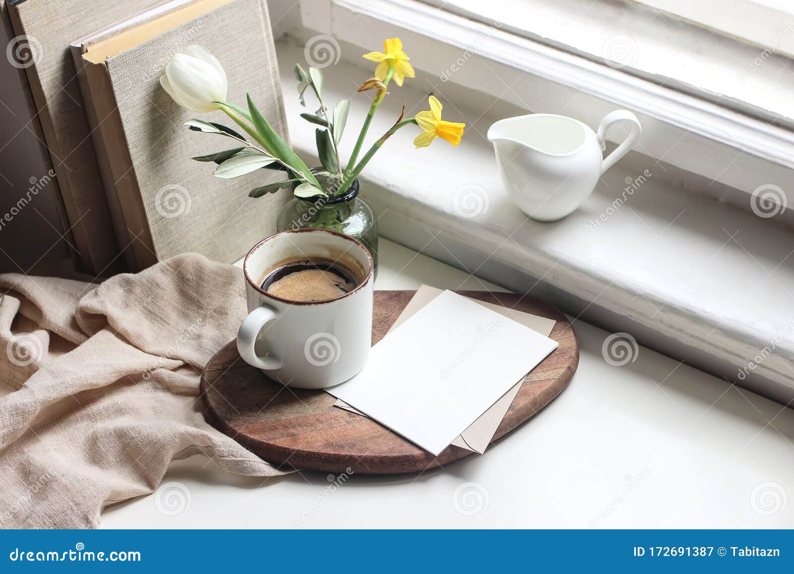 cozy easter spring still life. greeting card mockup scene. cup of coffee, books, wooden cutting board, milk pitcher and