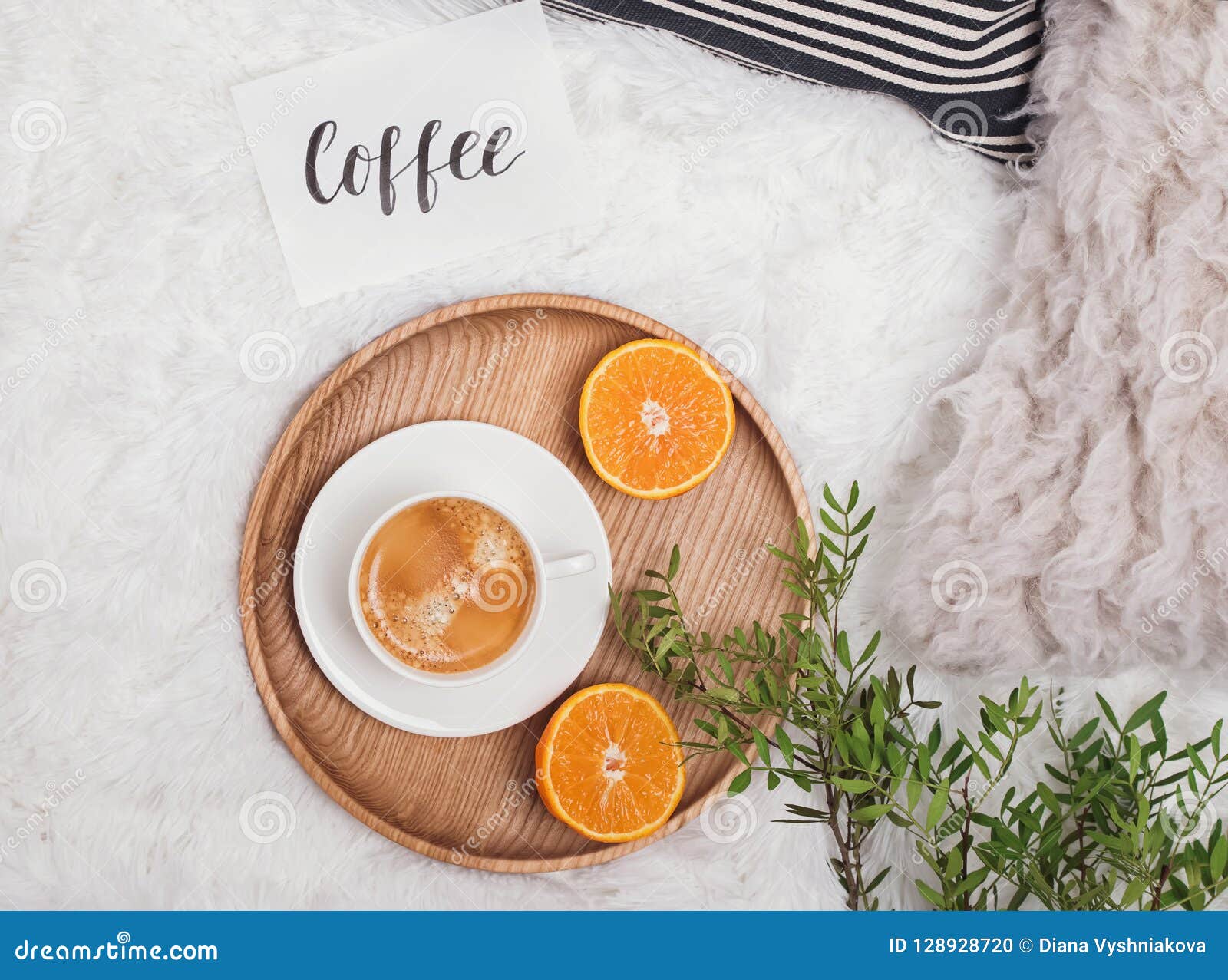 Cozy Flat Lay with Coffee, Green Branches and Oranges on the Bed. Stock