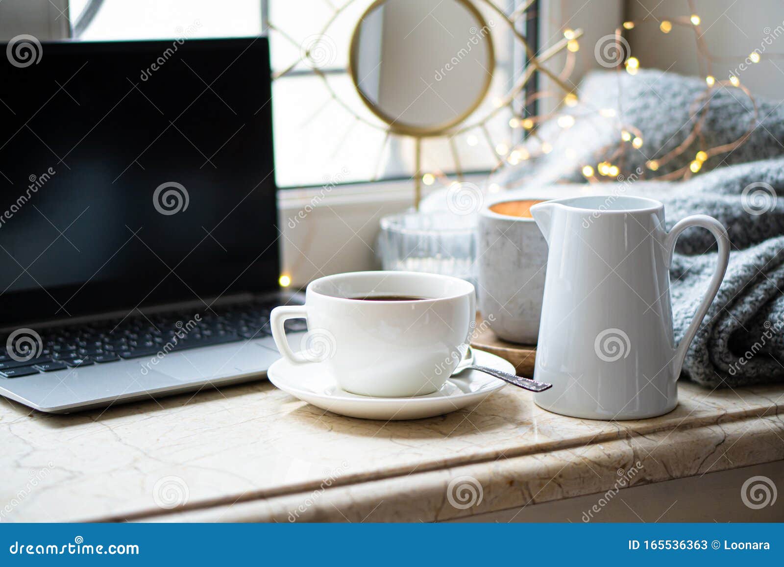 cozy freelancer`s winter work place at home with cup of coffee