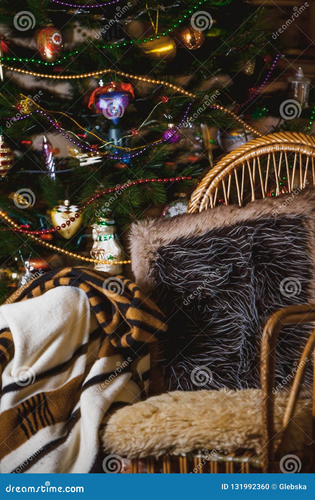 Wicker Chair on Background of Christmas Tree with Toys Stock Photo