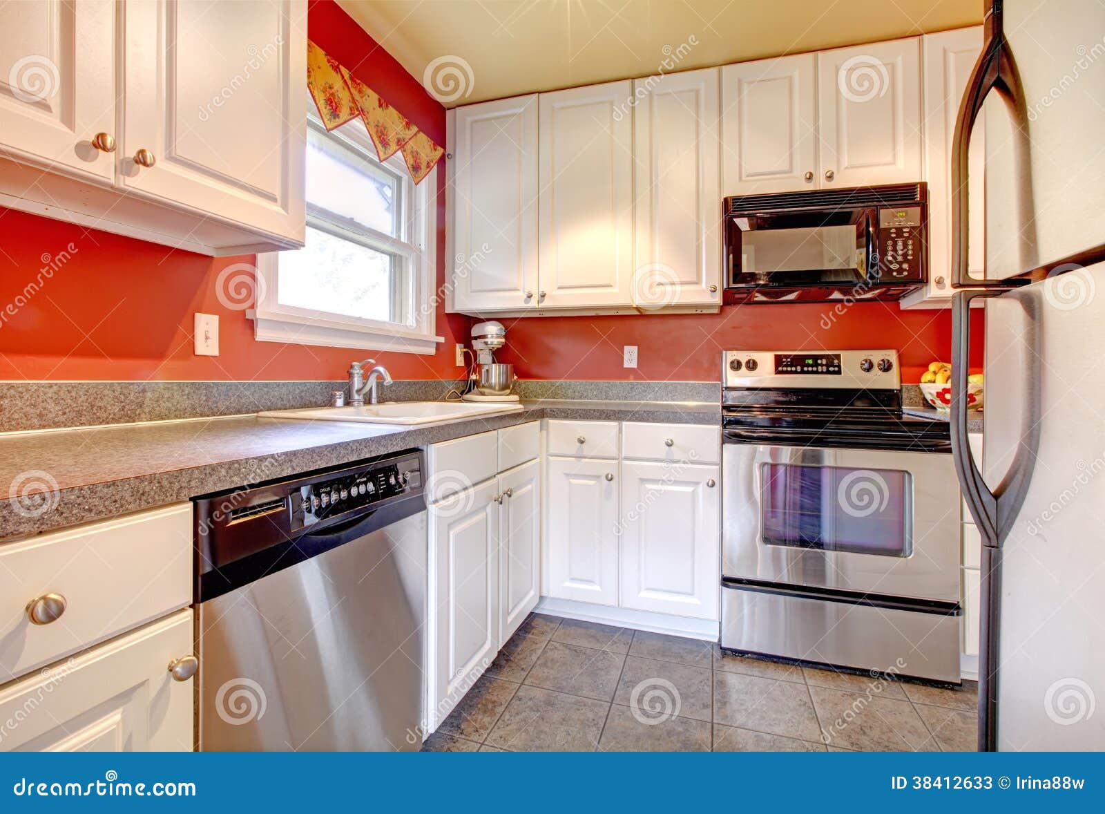 Cozy Kitchen Room with Red Wall and White Cabinets Stock Image - Image