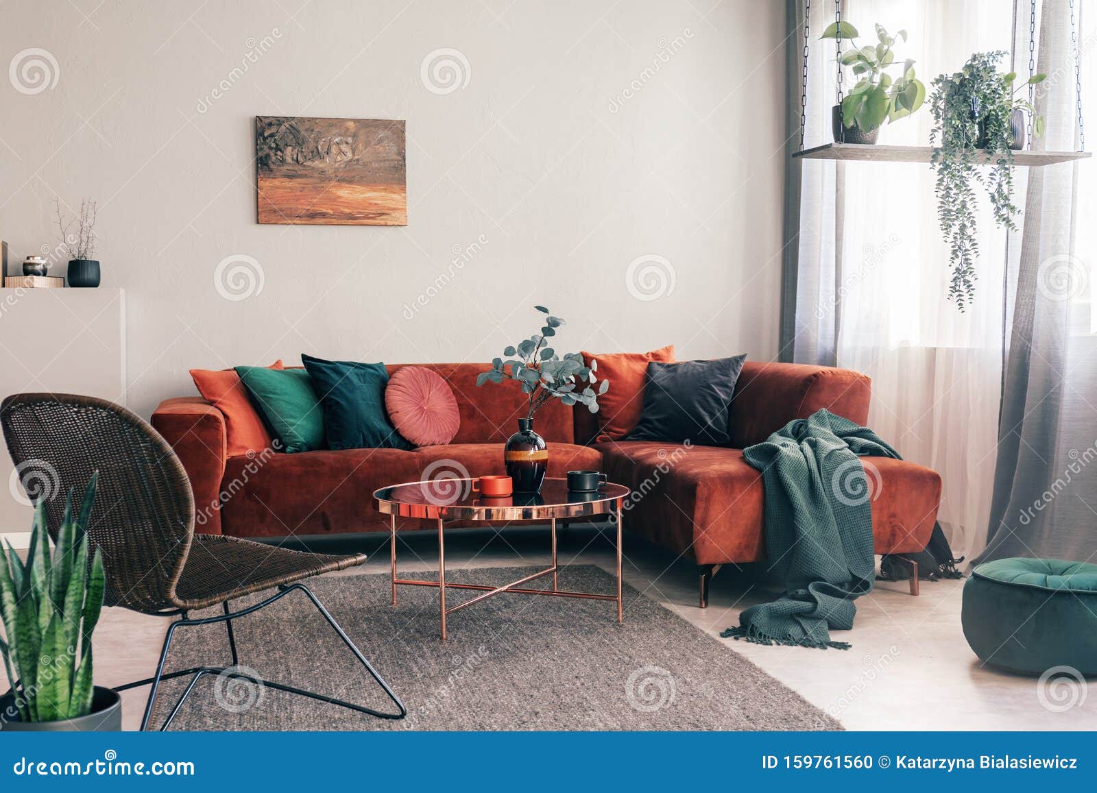 cozy living room interior with corner sofa with pillows and painting on the wall