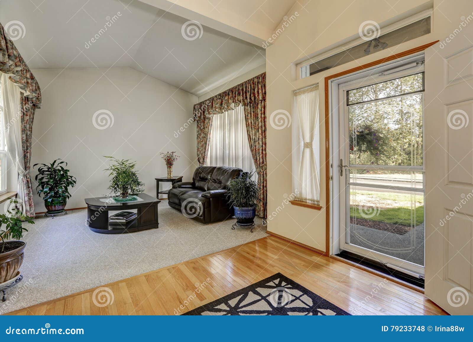 Cozy Sitting Area With Elegant Window Curtains And Vaulted Ceiling