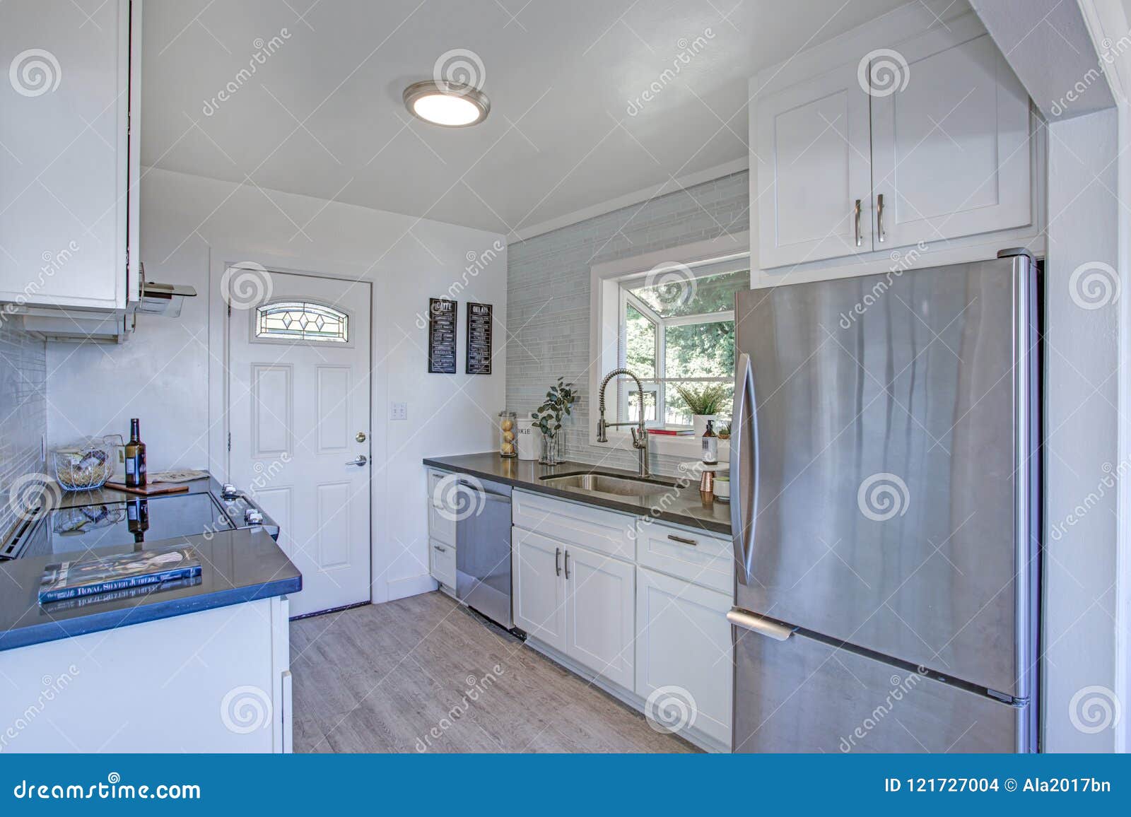 Cozy And Small Kitchen With White Cabinets Stock Photo Image Of