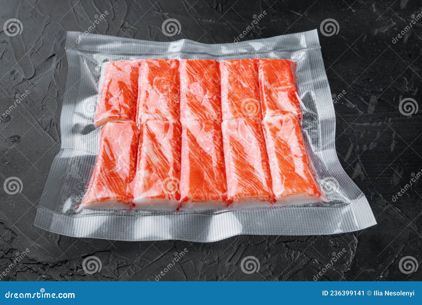 Crab Fish Meat Sticks in Vacuum Pack, on Black Background Stock Image
