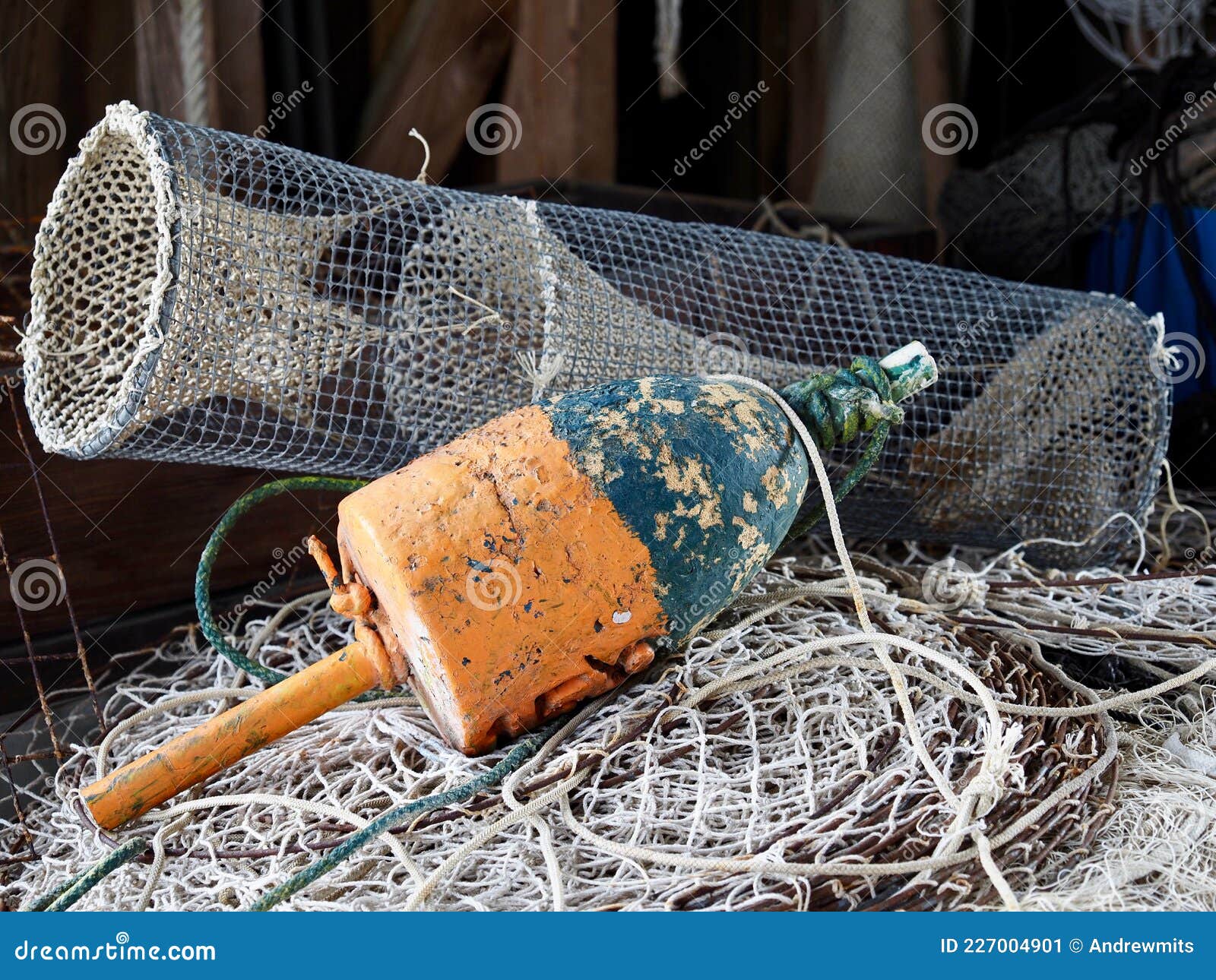 Crab Trap and Fishing Float Resting on Nets Stock Image - Image of