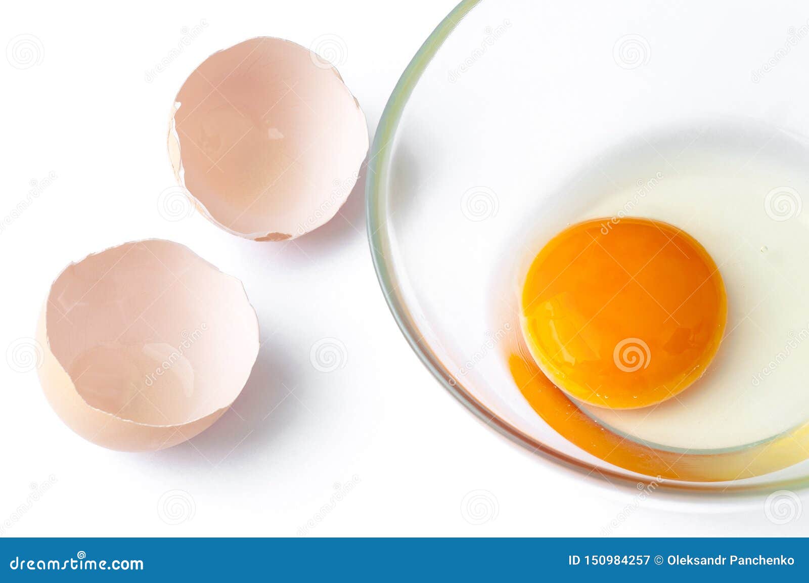Cracked Egg with Egg Shell, Egg Yolk and Egg in Glass Bowl Isolated on