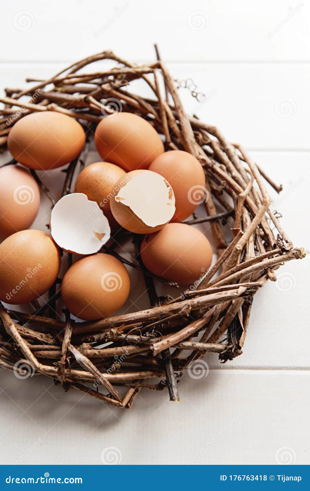 Cracked Egg Shells in a Nest Full of Eggs, on a White Table Stock Photo