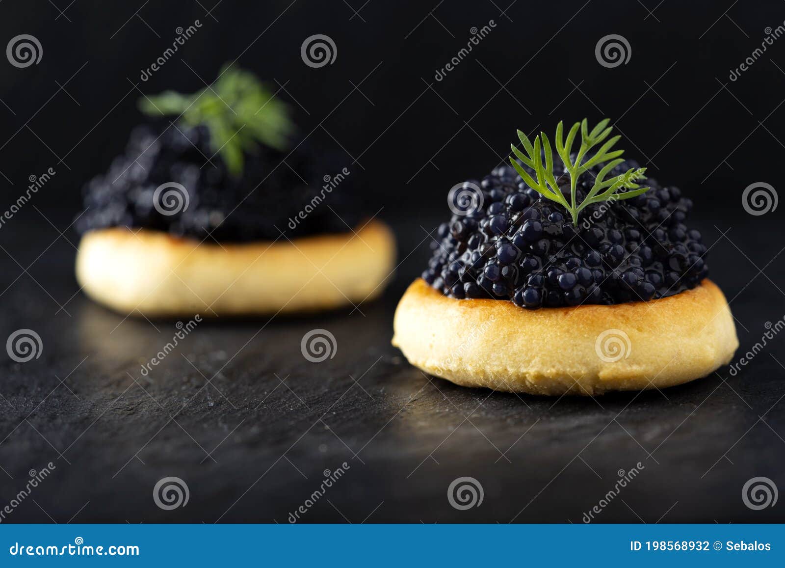 Crackers with black caviar stock photo. Image of apetizers 198568932