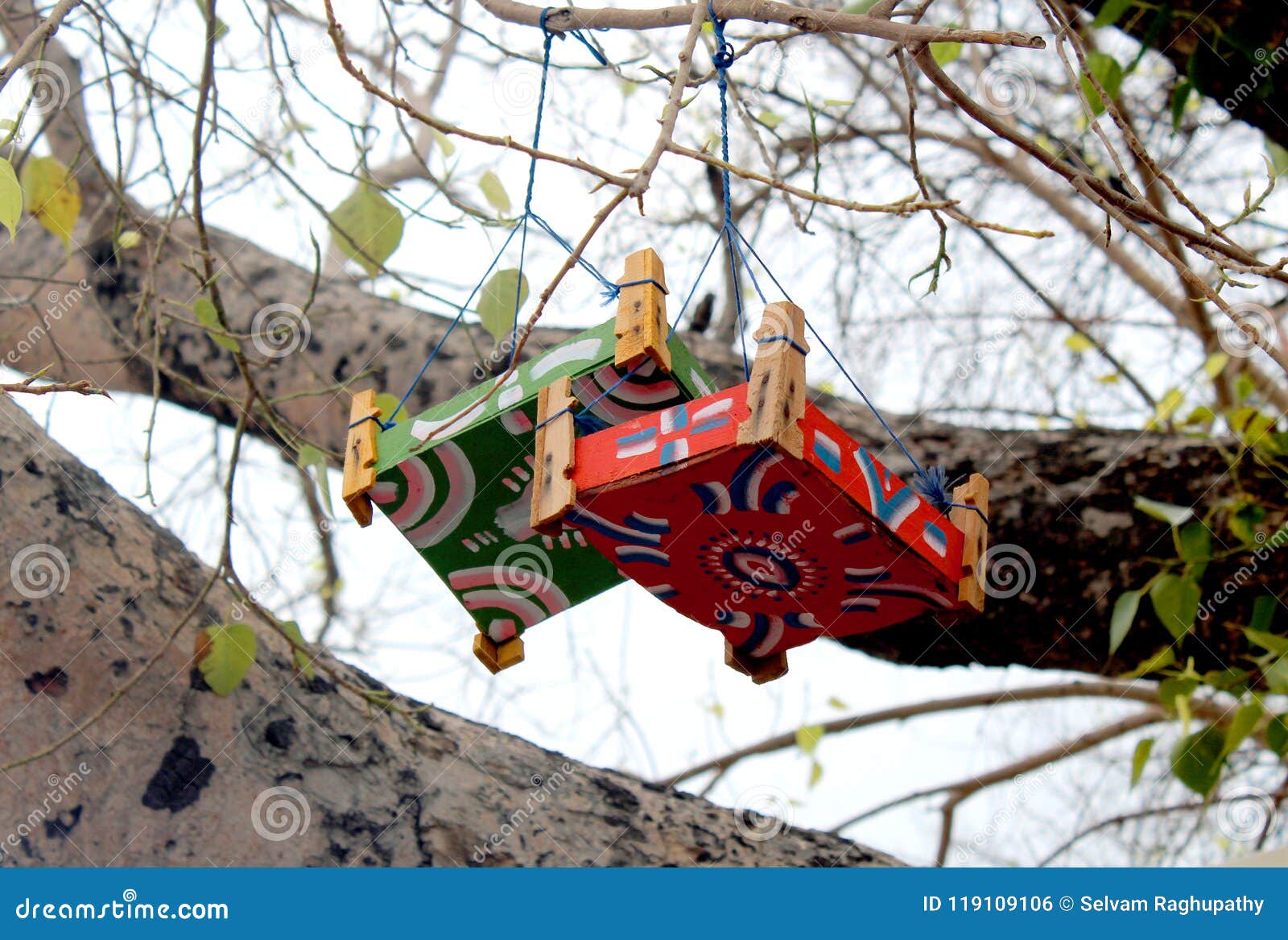 toy cradles on the tree.