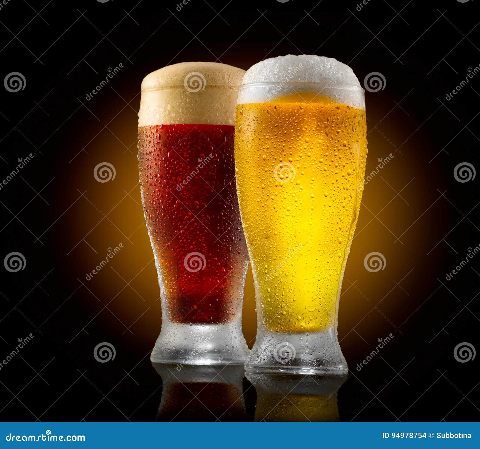 craft beer. two glasses of cold light and dark beer  on black