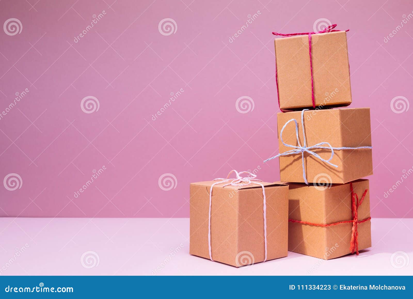 Craft Cardboard Gift Boxes on the Solid Pink Background. Holiday Stock ...