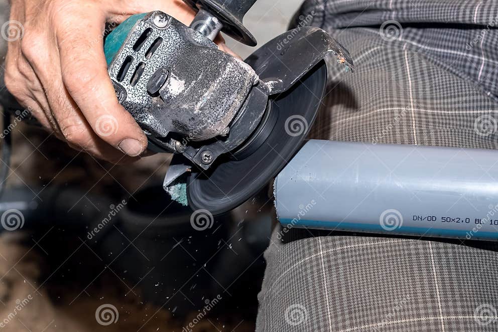 A Craftsman Cuts a PVC Pipe Using an Xangle Grinder Stock Photo Image of equipment