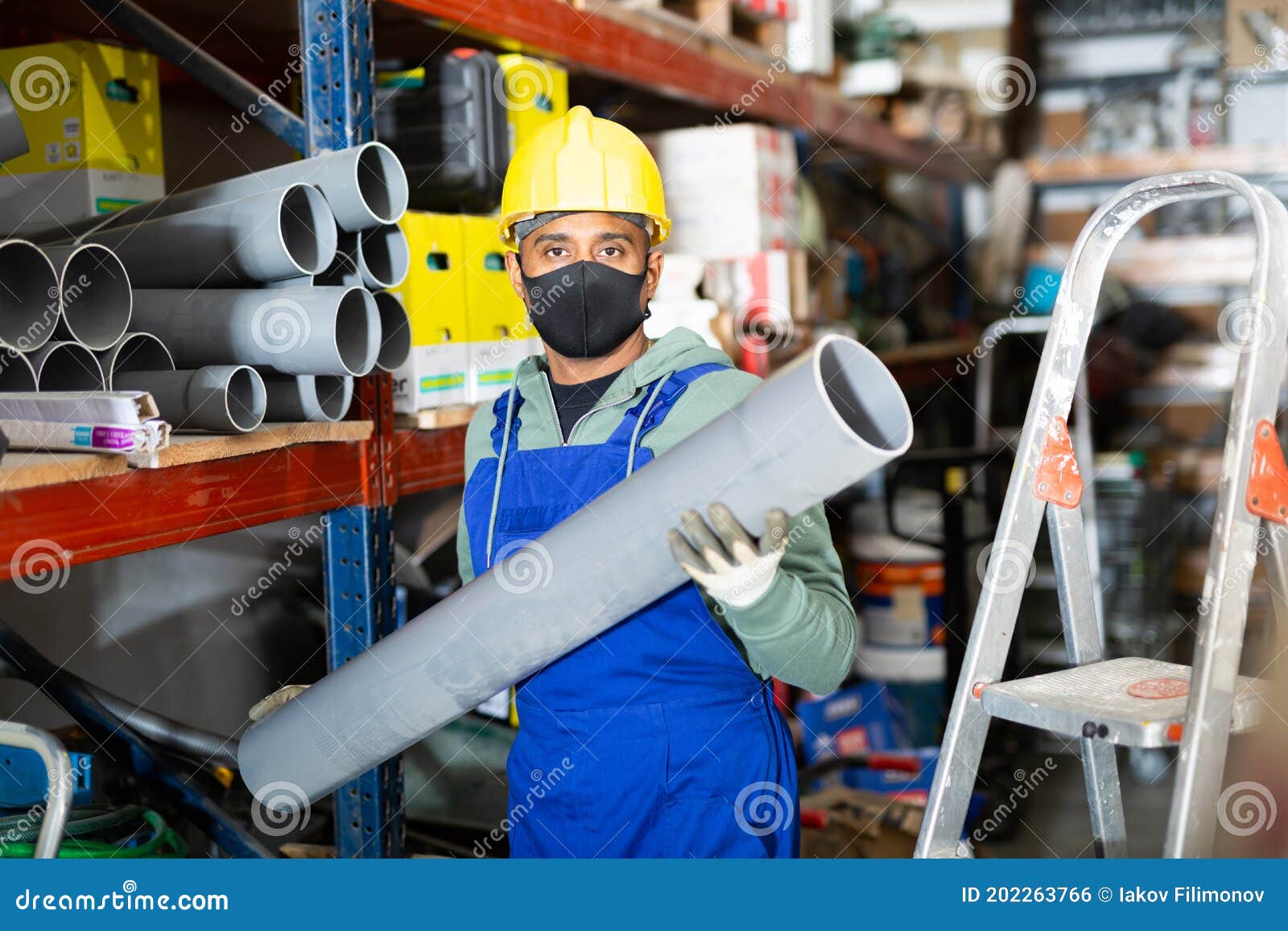 Craftsman in Protective Mask with Plumbing Pipe at Hardware Store Stock