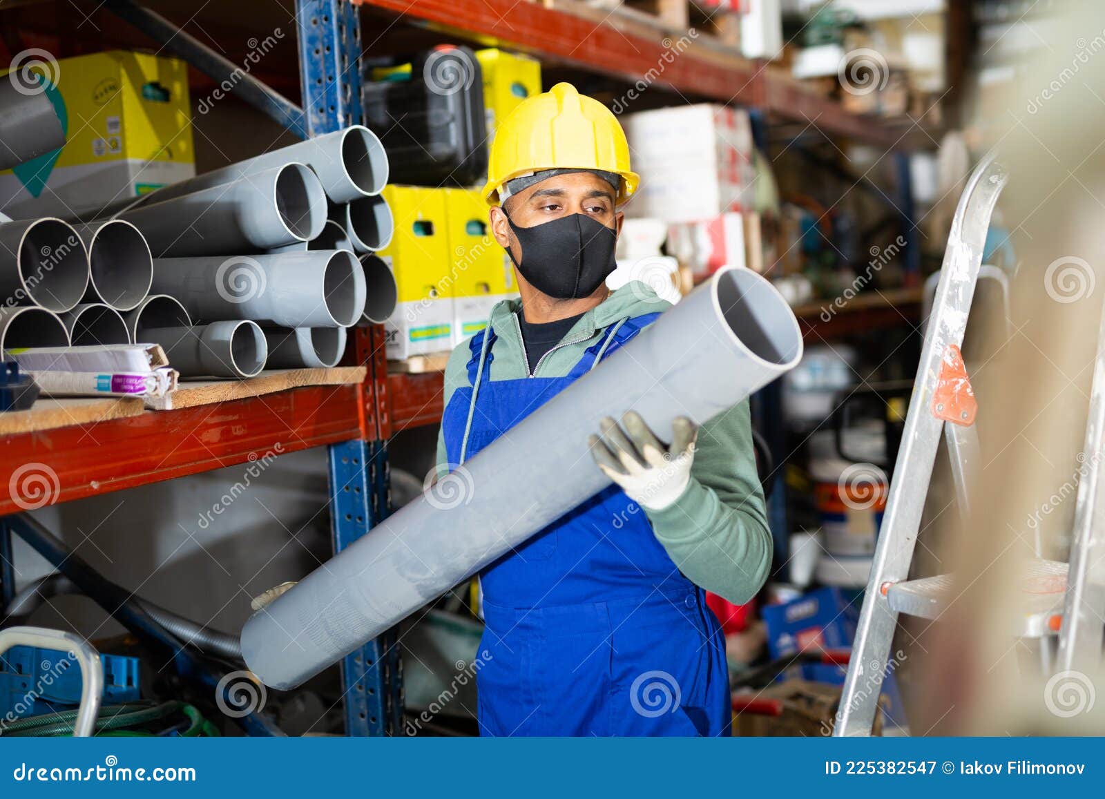 Craftsman in Protective Mask with Plumbing Pipe at Hardware Store Stock