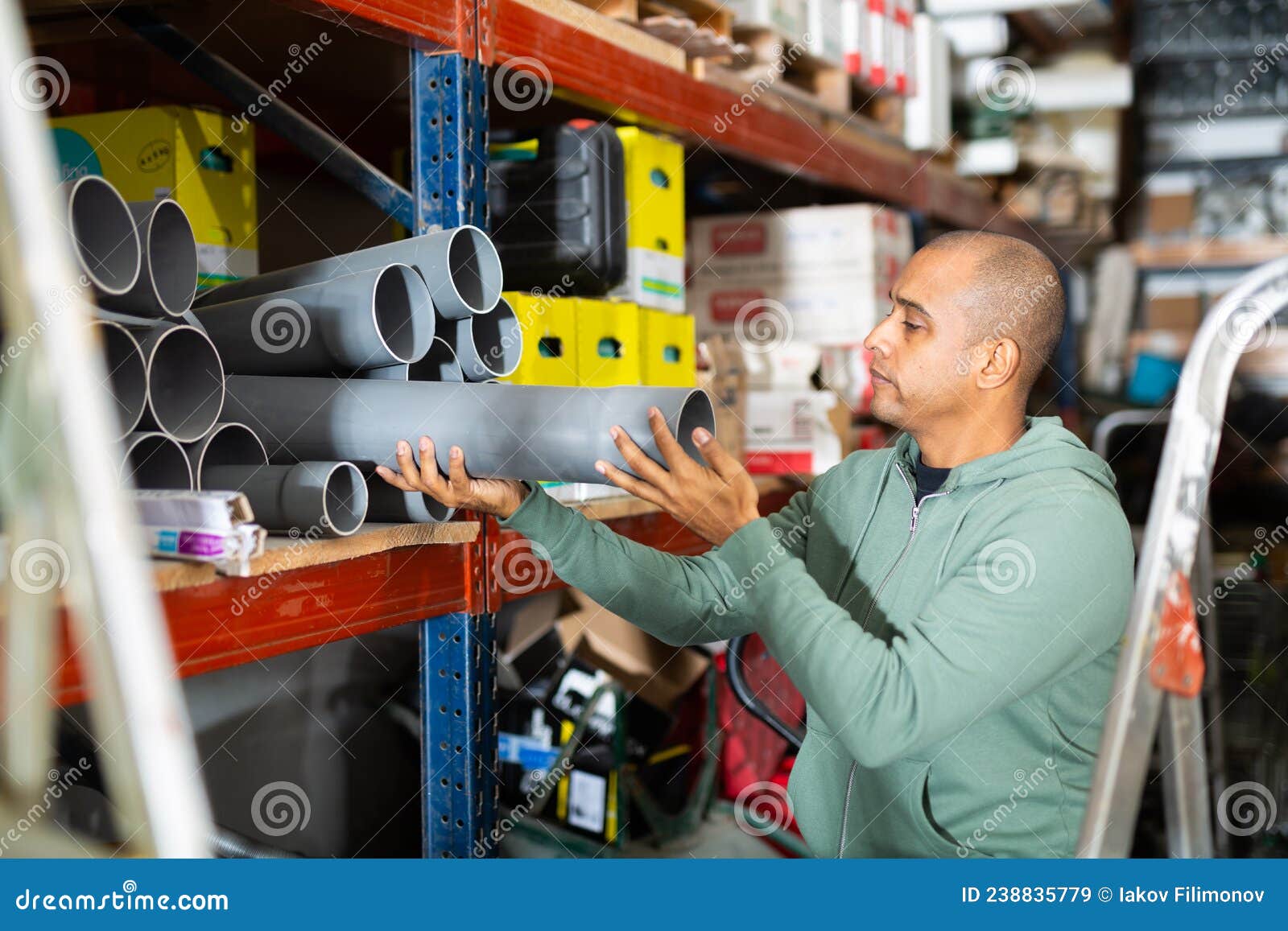 Craftsman Selects Plastic Plumbing Pipes in Hardware Store Stock Image