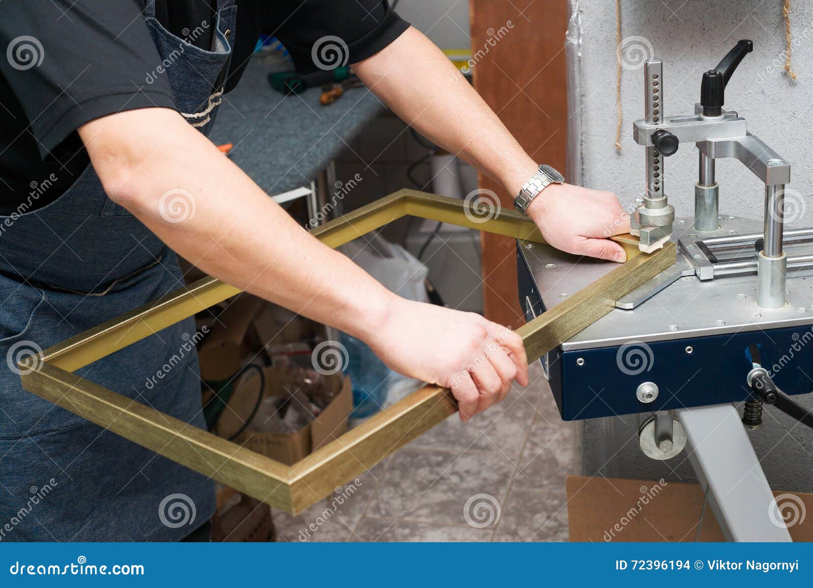 craftsman working on frame in frameshop. professional framer. top view.