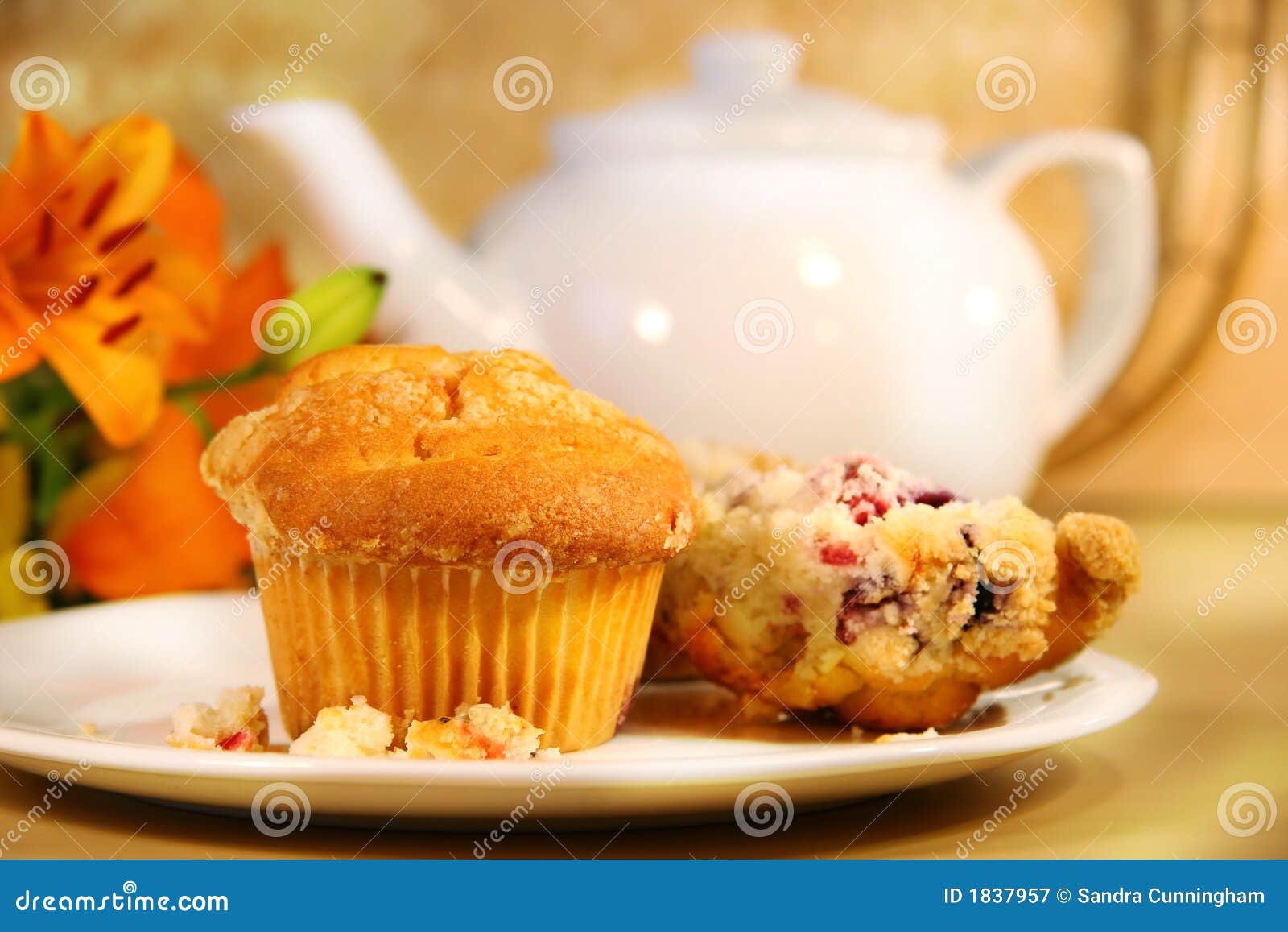 Cranberry muffins for breakfast. Breakfast with cranberry muffins, teapot and orange juice on bamboo mat