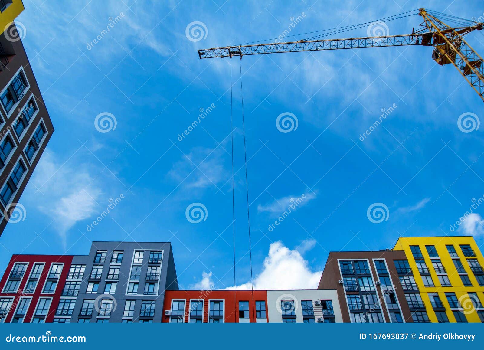 crane. construction crane. building crane on the background of colored buildings