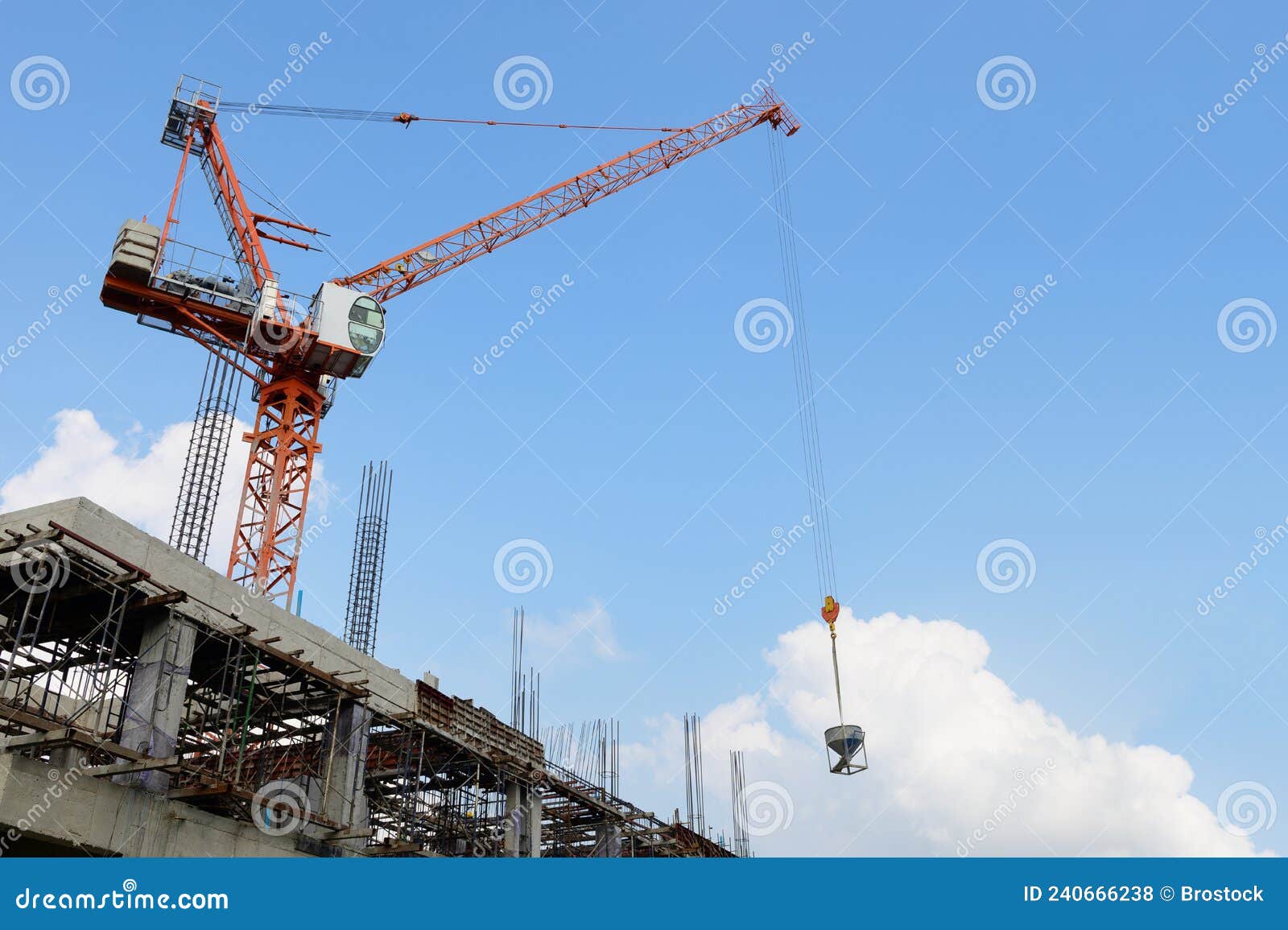 Crane Lifting Concrete Bucket on Construction Site Stock Photo Image