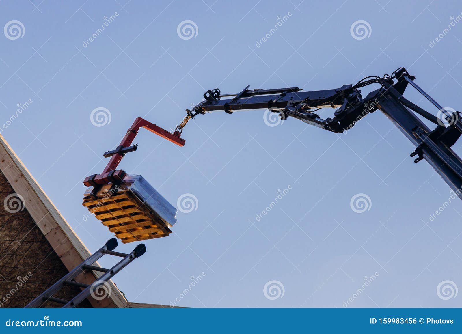Crane Lifting Materials Roofing Construction at Work Stock Photo