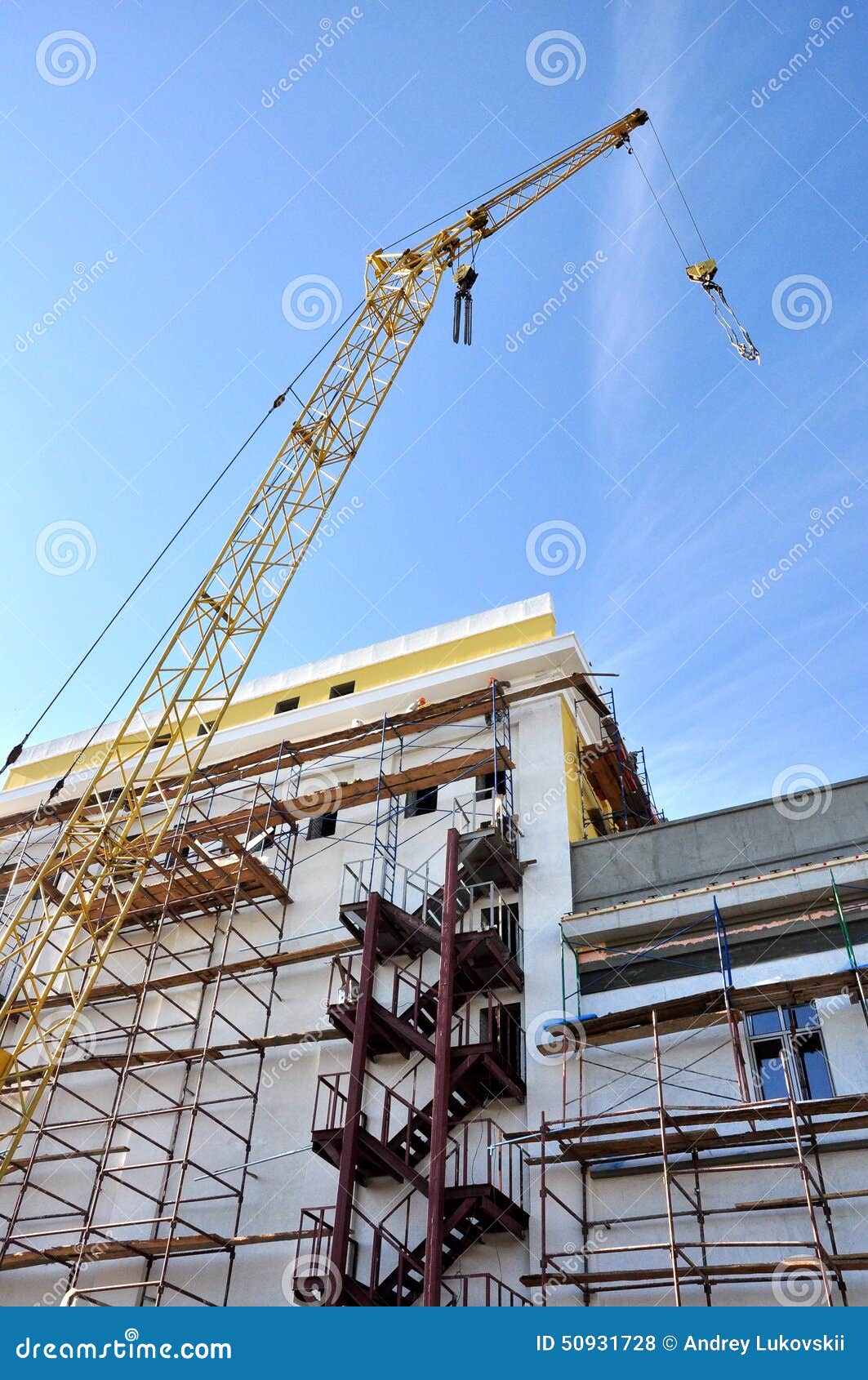 A Crane Lifts the Load on the Construction Stock Photo Image of