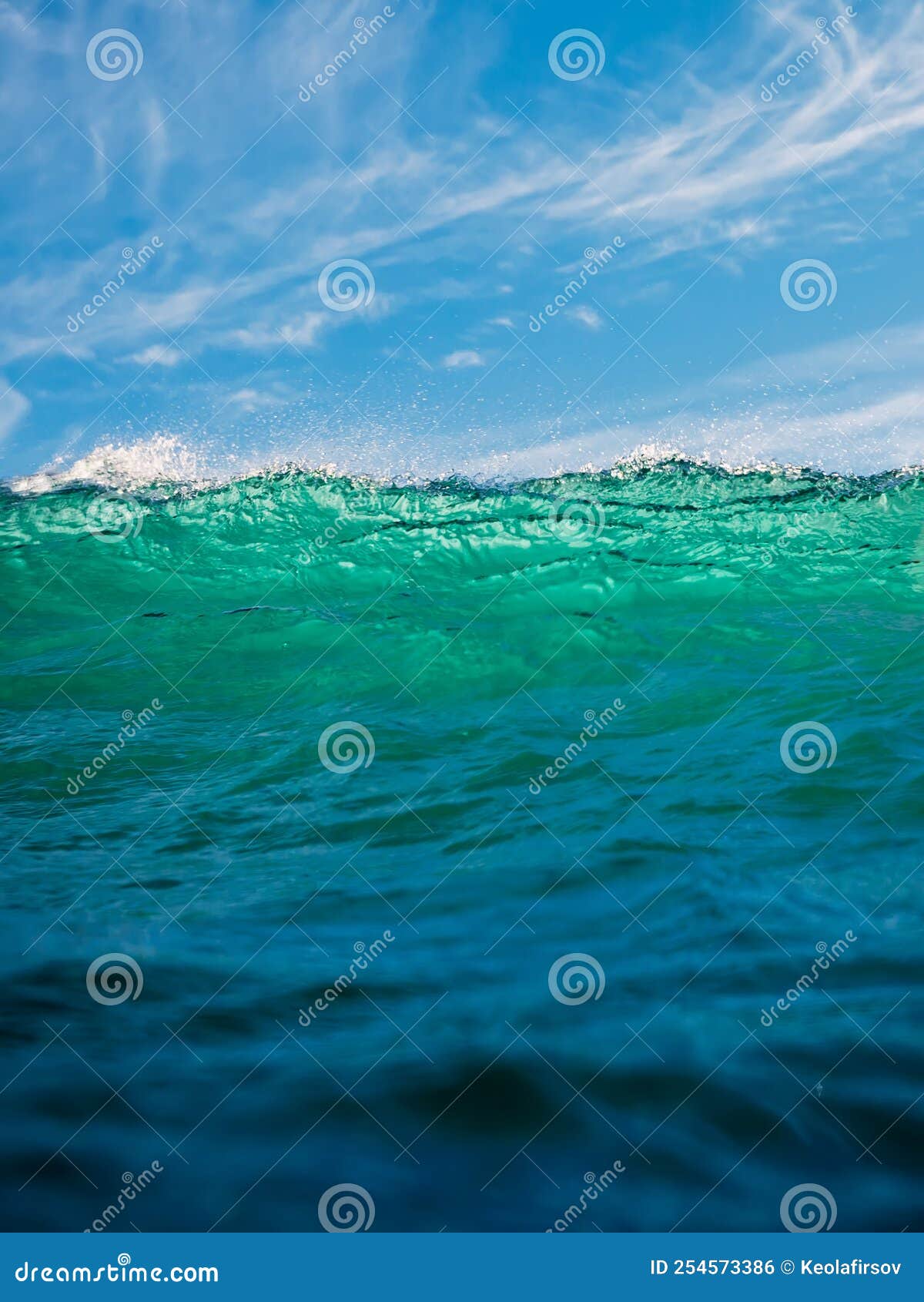 Crashing Wave in Ocean. Breaking Turquoise Wave with Sun Light and Blue