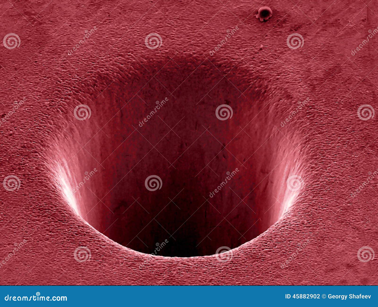 crater in metal drilled by laser beam