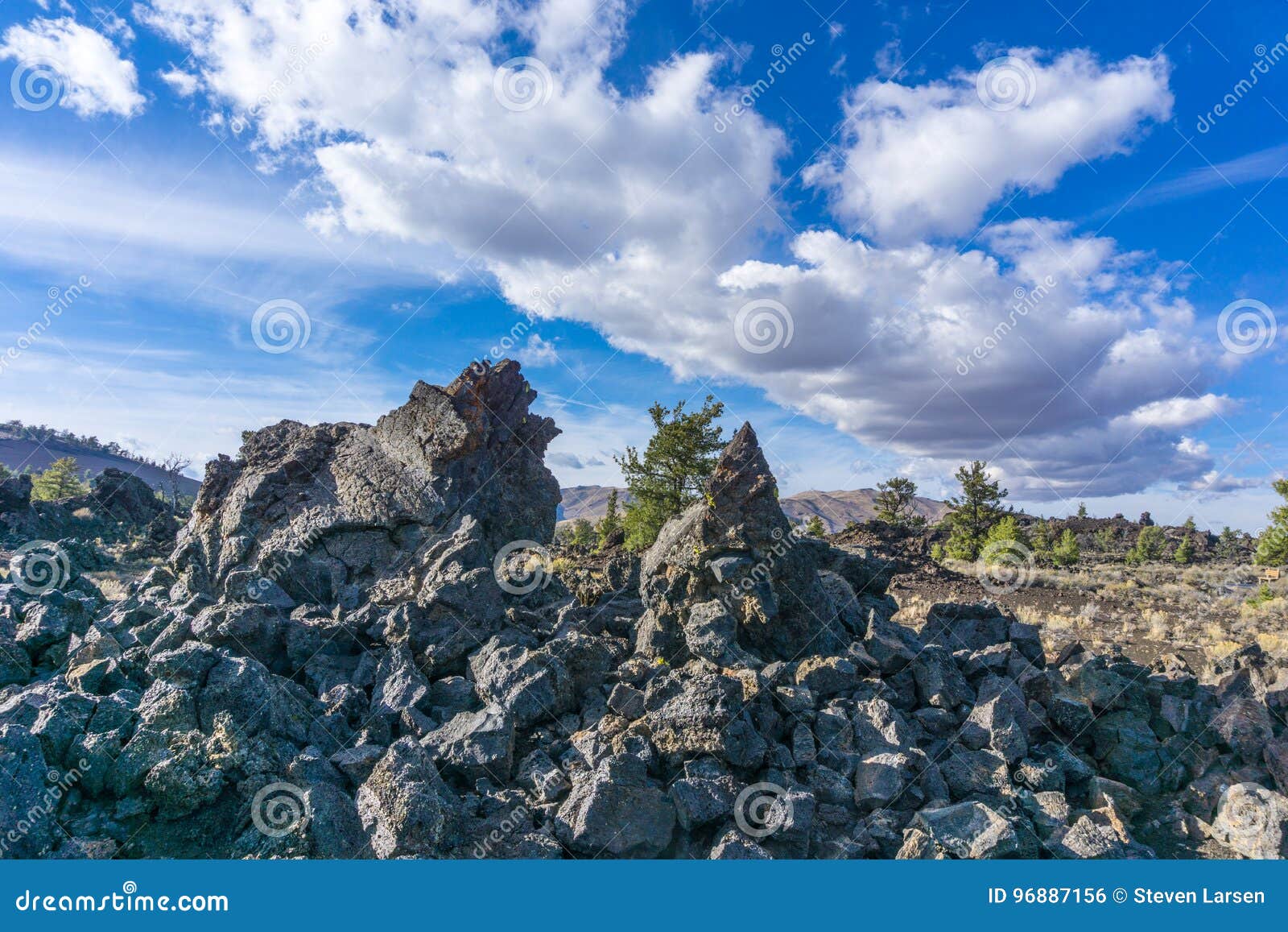 https://thumbs.dreamstime.com/z/craters-moon-national-monument-vista-sharp-rocks-vivid-blue-sky-high-white-clouds-over-rugged-lava-fields-96887156.jpg