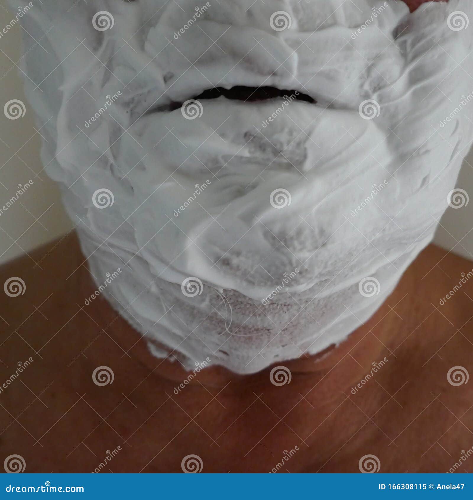 crazy man with shaving cream on the face makes a selfie