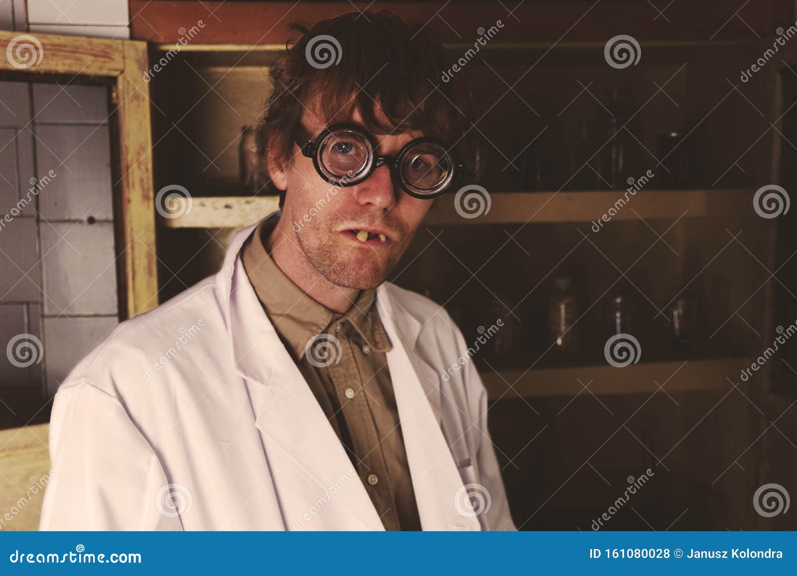 crazy scientist with creepy face in his laboratory