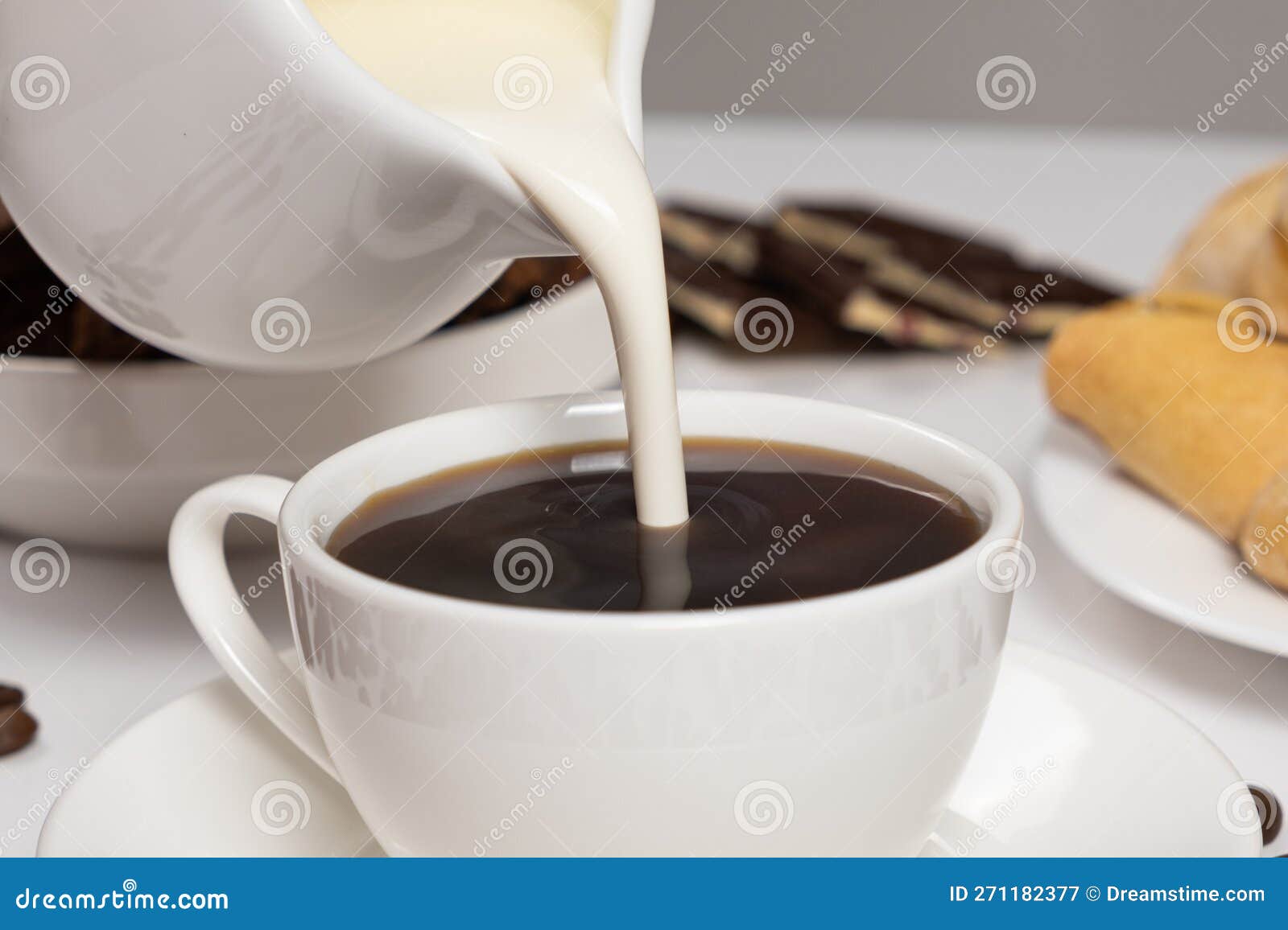 Cream from the Milk Jug is Poured into Coffee, Making Coffee with Cream