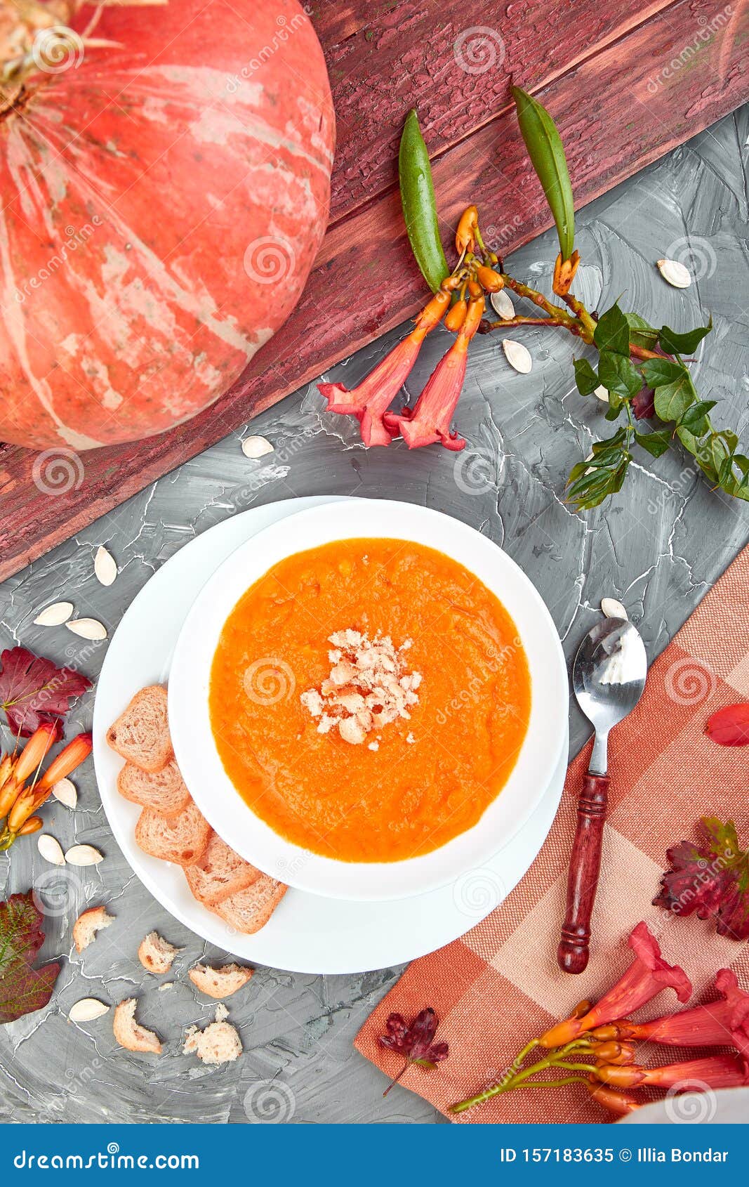 cream of pumpkin soup on a gray background. diet vegetarian pupmkin soup