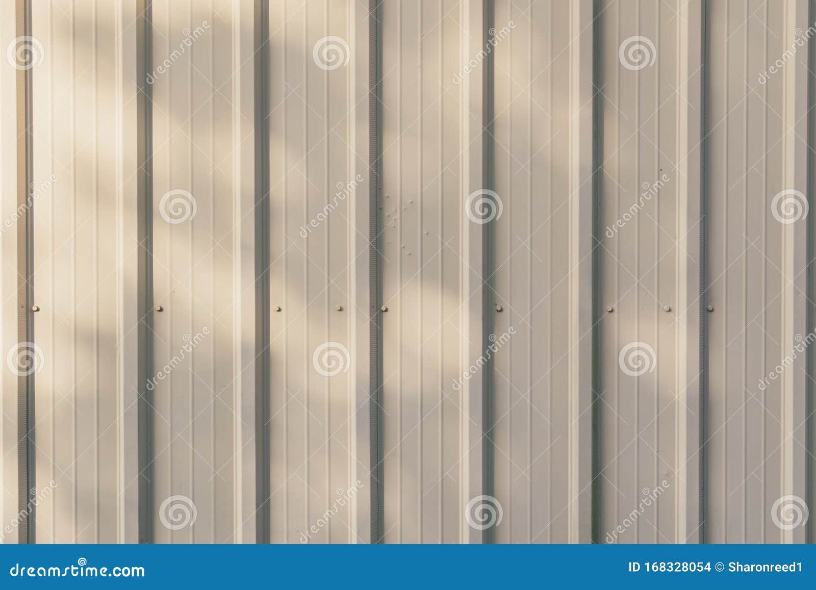 Cream Metal Siding Wall with Shadows Background Texture Stock Photo