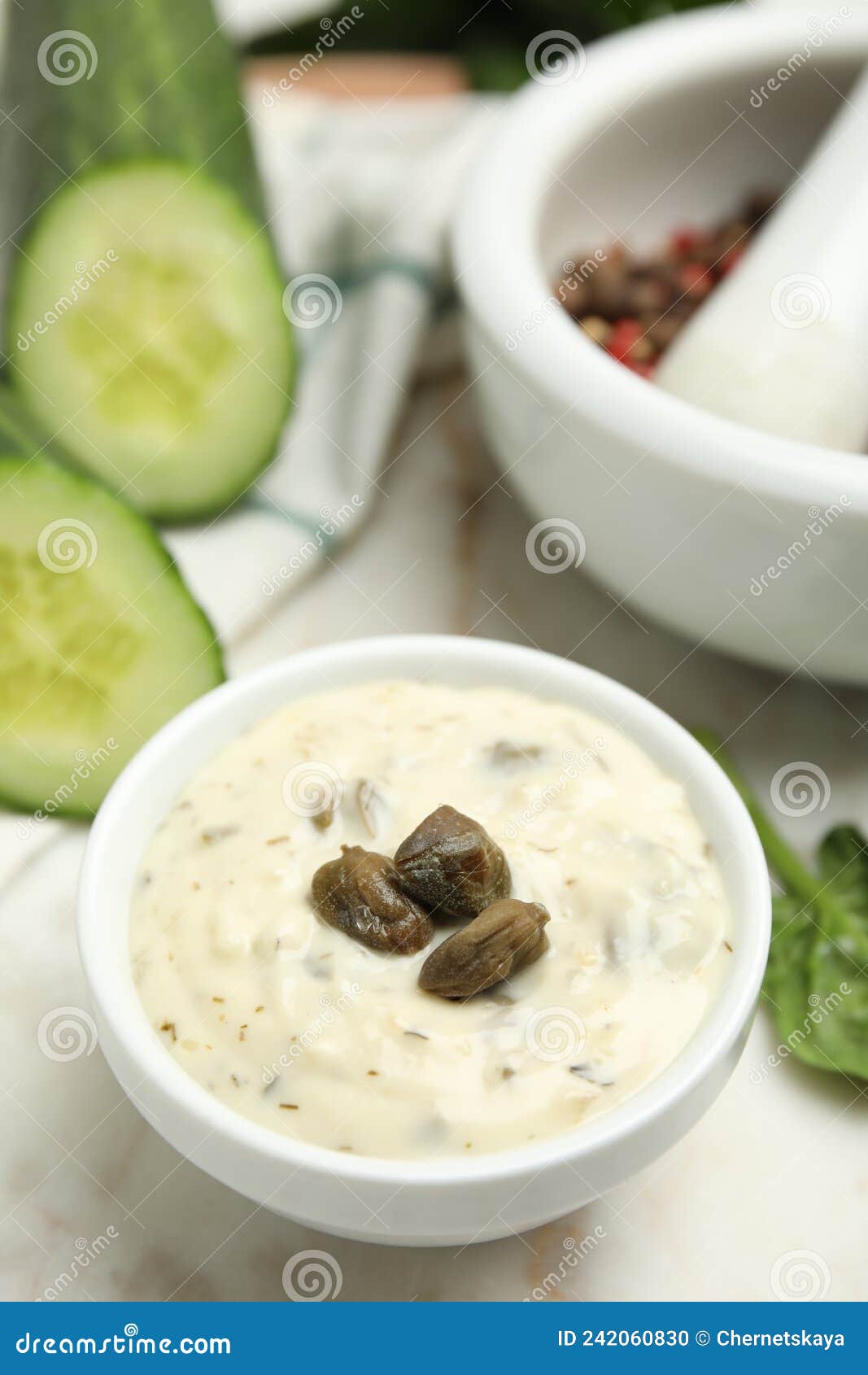 Creamy Caper Sauce in Bowl on White Table, Closeup Stock Photo Image